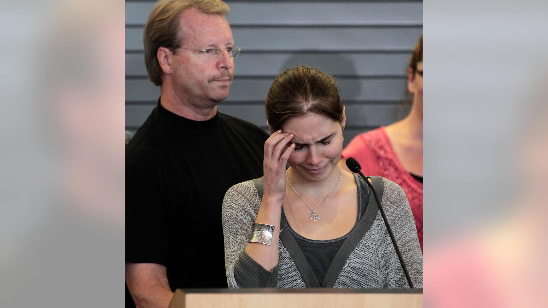 Oct. 4, 2011: Amanda Knox tries to gain her composure to make a statement to the media as her father, Curt Knox, stands behind, shortly after her arrival at Seattle-Tacoma International Airport in Seattle. Knox was freed on October 3 after an Italian appeals court acquitted her on murder charges after four years in prison. Curt Knox says Amanda would like to go back to her university and finish her degree, but that he worries about what the time in prison has done to his 24-year-old daughter.