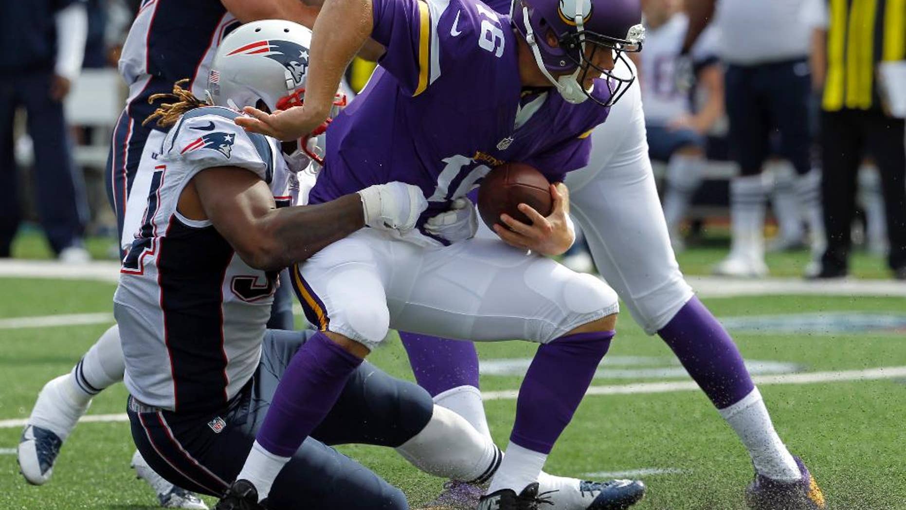 Minnesota Vikings quarterback Matt Cassel, right, is sacked for an 8-yard loss by New England Patriots linebacker Dont'a Hightower during the third quarter of an NFL football game Sunday, Sept. 14, 2014, in Minneapolis. (AP Photo/Ann Heisenfelt)