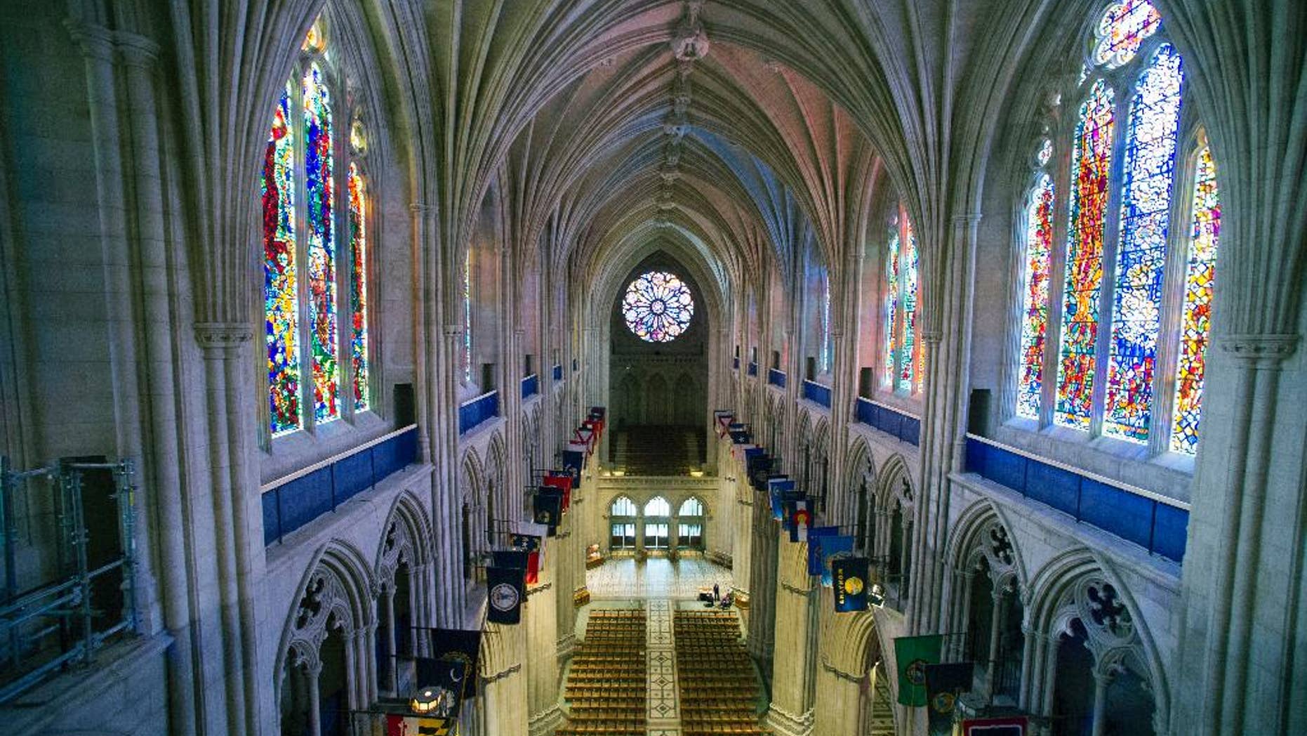FILE - This Wednesday, Feb. 18, 2015 file photo shows the nave of the Washington National Cathedral in Washington. A day after Donald Trump is sworn in, he and his cabinet members plan to attend a prayer service at the cathedral where "all faiths will be represented at his request," according to the Washington Episcopal bishop who oversees the cathedral. But the customary ceremony is complicated this time by anger over the president-elect’s rhetoric on Muslims, immigrants and others. (AP Photo/Cliff Owen)