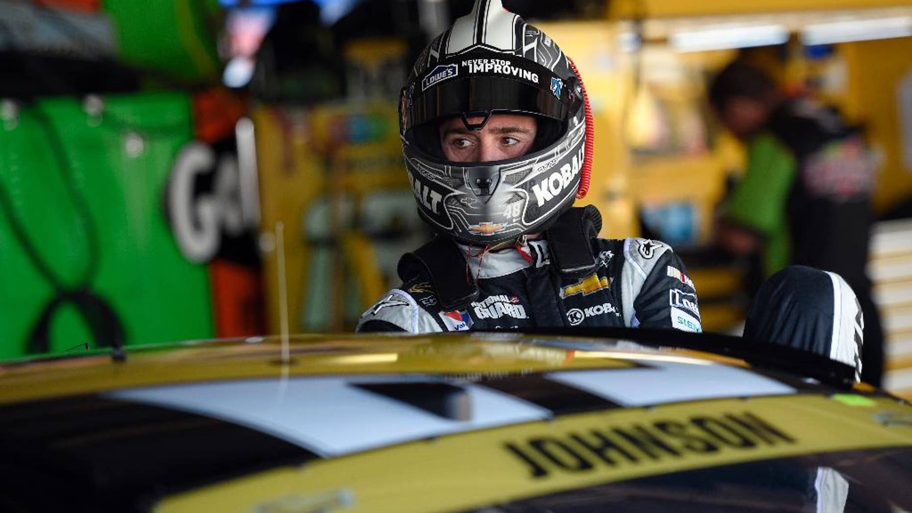 Driver Jimmie Johnson climbs into his car before practice for the NASCAR Sprint Cup series auto race, Friday, Sept. 26, 2014, at Dover International Speedway in Dover, Del. (AP Photo/Nick Wass)