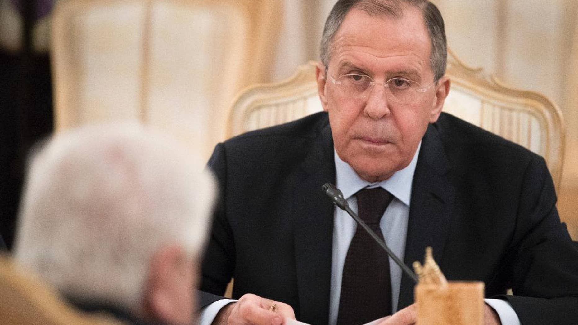 Russian Foreign Minister Sergey Lavrov listens to his Syrian counterpart Walid Muallem during their meeting in Moscow, Russia, on Thursday, April 13, 2017. Lavrov said he expected the OPCW ( Organization for the Prohibition of Chemical Weapons ) to conduct an extensive probe into the suspected nerve gas attack on Khan Sheikhoun, Syria, which could produce a report within about three weeks, the British delegation to the commission said Thursday. (AP Photo/Pavel Golovkin)
