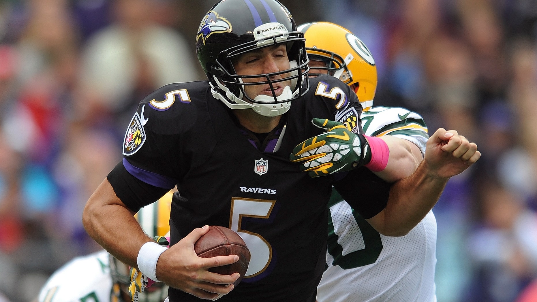 Baltimore Ravens quarterback Joe Flacco (5) is sacked by Green Bay Packers inside linebacker A.J. Hawk during the first half of an NFL football game in Baltimore, Sunday, Oct. 13, 2013. (AP Photo/Gail Burton)