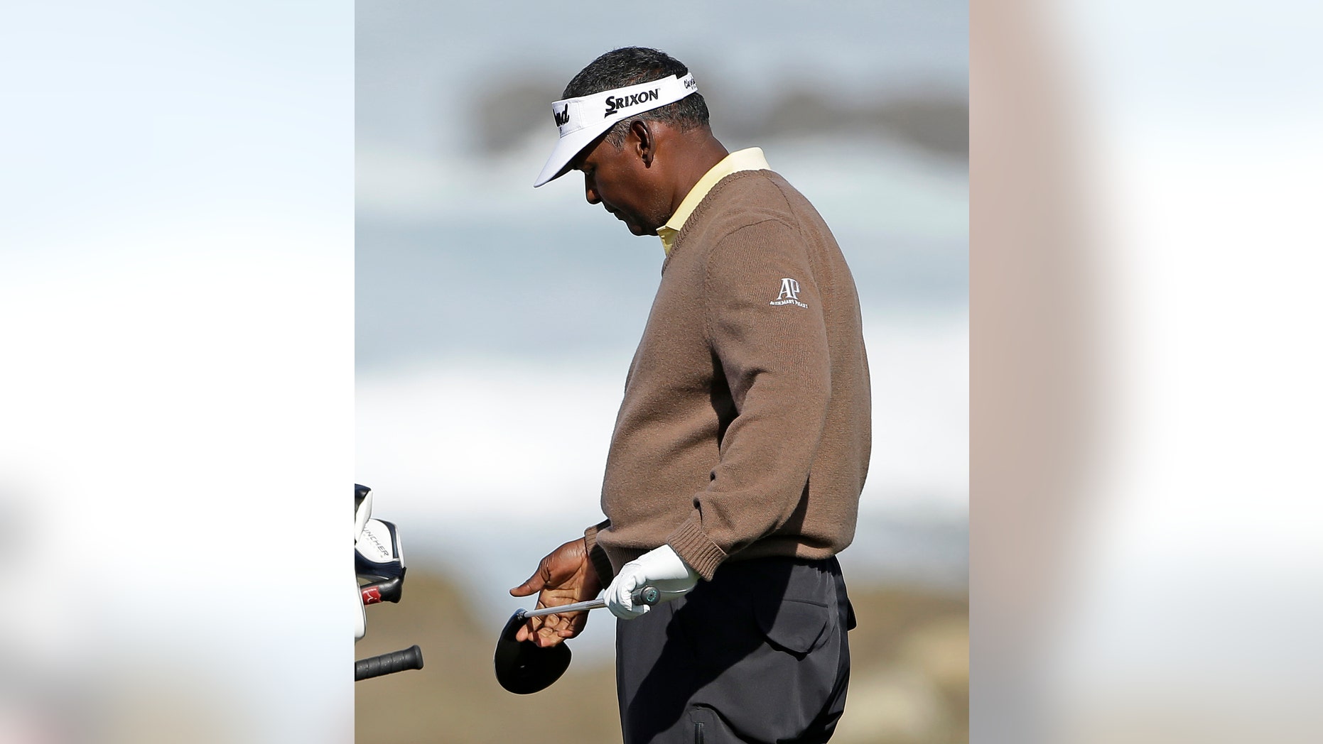 Vijay Singh, of Fiji, looks over his driver before hitting from the 13th tee of the Monterey Penisnula Country Club Shore Course during the second round of the AT&T Pebble Beach Pro-Am golf tournament on Friday, Feb. 8, 2013, in Pebble Beach, Calif. (AP Photo/Eric Risberg)