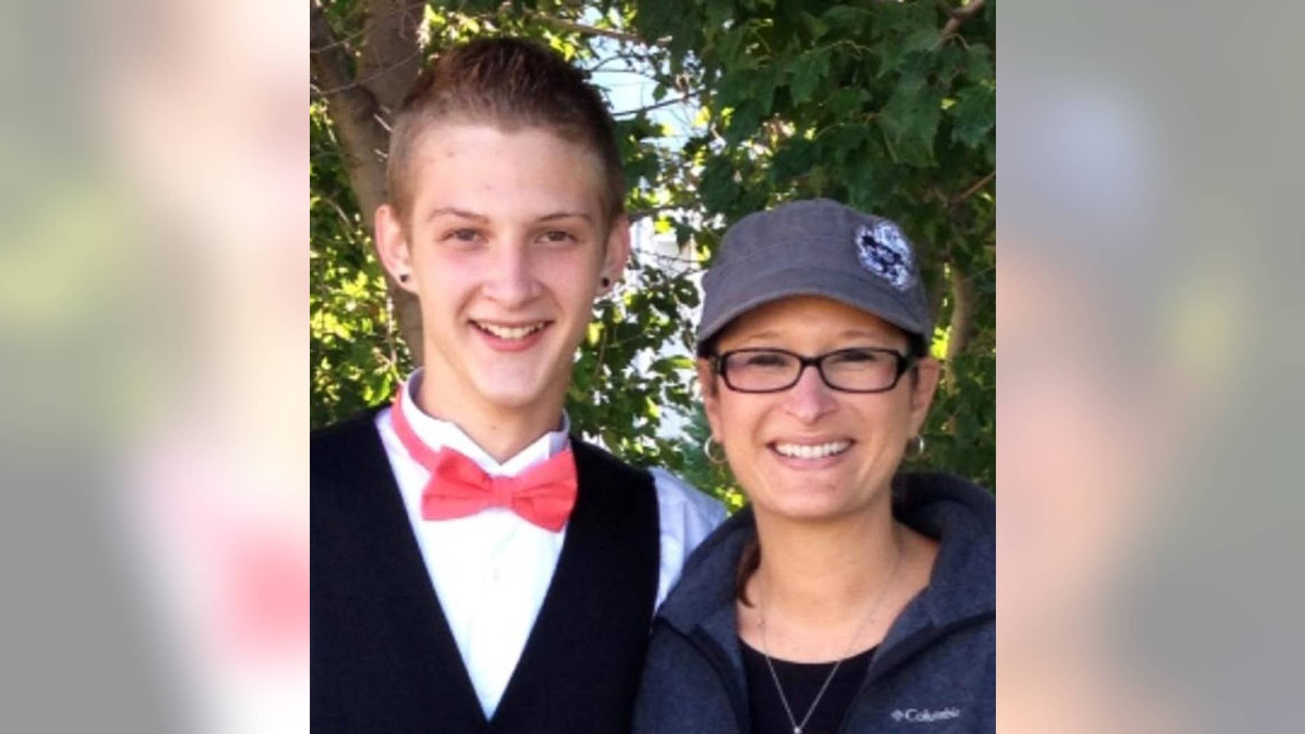 In this photo provided by Daniel J. Haus, attorney for the family, is Bryce Masters with his mother, Stacy Masters. The FBI is investigating after a police officer in suburban Kansas City, Missouri, used a stun gun to subdue 17-year-old Bryce during a traffic stop Sunday, Sept. 14, 2014, leaving him hospitalized in critical condition. (AP Photo/family photo via Daniel Haus)