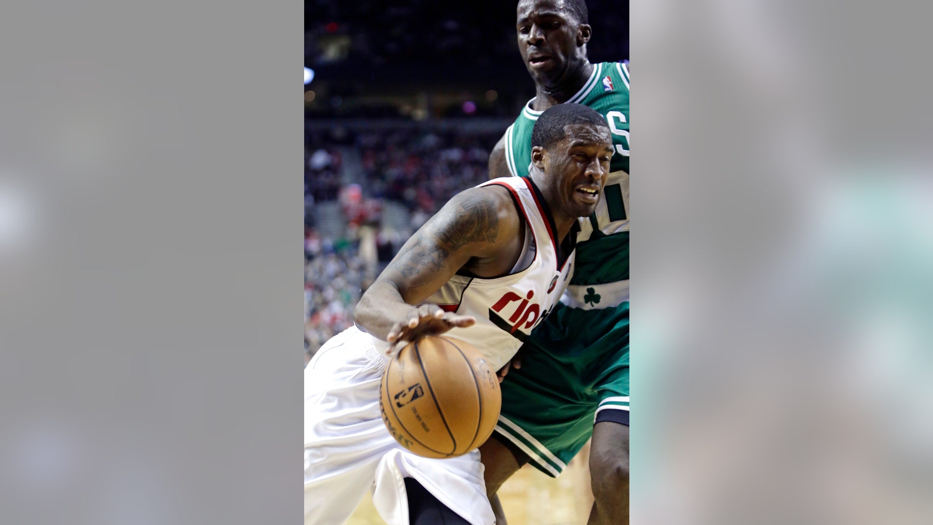 Portland Trail Blazers guard Wesley Matthews, left, drives the baseline against Boston Celtics forward Brandon Bass during the second half of an NBA basketball game in Portland, Ore., Sunday, Feb. 24, 2013. Matthews led the Trail Blazers in scoring with 24 points as they beat the Celtics 92-86.(AP Photo/Don Ryan)