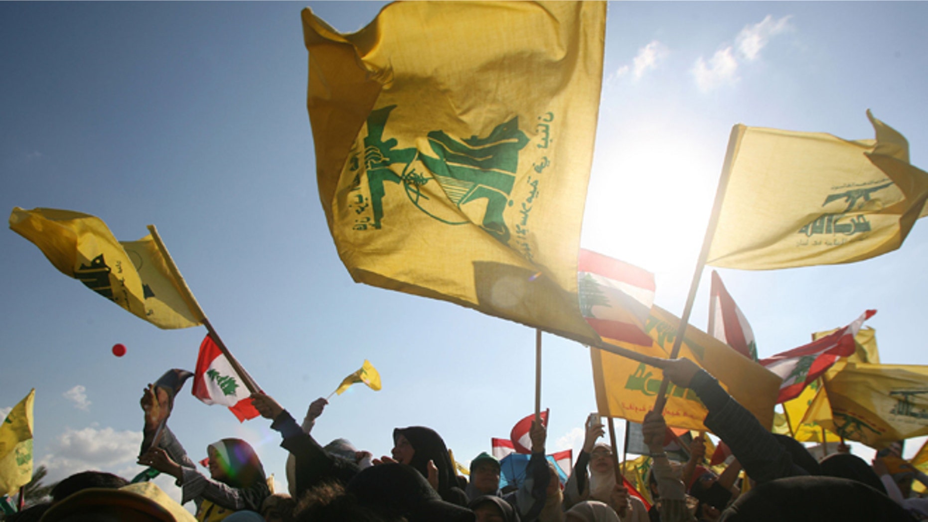 BEIRUT, LEBANON- SEPTEMBER 22: Hezbollah supporters wave flags during a ''Victory over Israel'' rally in Beirut's suburbs on September 22, 2006 in Beirut, Lebanon. Hezbollah leader Sayyed Hassan Nasrallah reportedly said that Hezbollah would not disarm until a Lebanese government capable of protecting the country was in place during the rally. (Photo by Salah Malkawi/Getty Images)