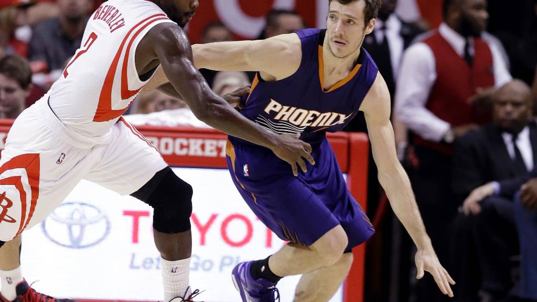 Phoenix Suns' Goran Dragic (1) is pressured by Houston Rockets' Patrick Beverley (2) in the second half of an NBA basketball game Saturday, Dec. 6, 2014, in Houston. The Rockets won 100-95. (AP Photo/Pat Sullivan)