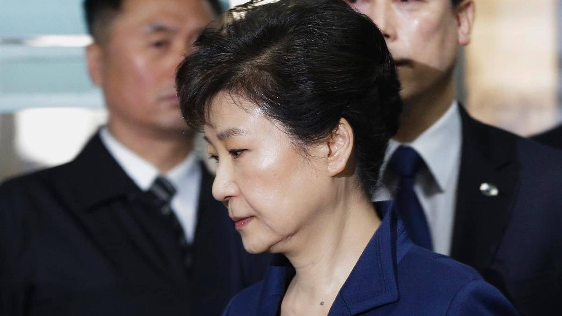 FILE - In this March 30, 2017 file photo, ousted South Korean President Park Geun-hye arrives at the Seoul Central District Court for hearing on a prosecutors' request for her arrest for corruption, in Seoul, South Korea. The arrest of South Korea's first female president marks a stunning fall for the scion of a powerful general who himself ruled the country during her teenage years and into her 20s. Park was jailed Friday, March 31, 2017, three weeks after the Constitutional Court stripped her of office over a corruption scandal. Prosecutors accuse her of colluding with a jailed confidante to amass an illicit fortune and allowing the friend to manipulate state affairs. (AP Photo/Ahn Young-joon, File)