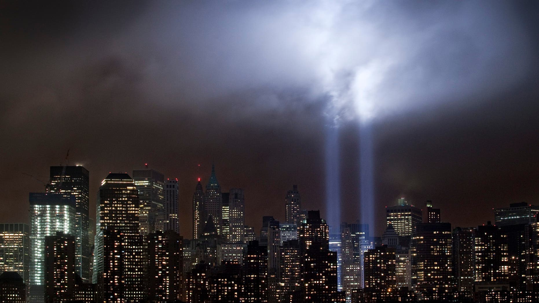 A test of the Tribute in Light rises above lower Manhattan, Tuesday, Sept. 6, 2011, in New York. Four World Trade Center, second from left, is under construction. The memorial, sponsored by the Municipal Art Society, will light the sky on the evening of Sept. 11, 2011, in honor of those who died ten years ago in the terror attacks on the United States. (AP Photo/Mark Lennihan)
