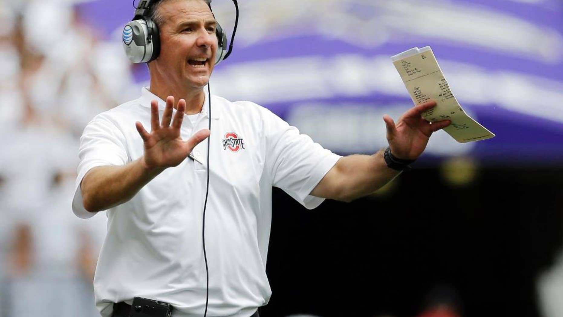 Ohio State head coach Urban Meyer directs his players in the second half of an NCAA college football game against Navy in Baltimore, Saturday, Aug. 30, 2014. Ohio State won 34-17. (AP Photo/Patrick Semansky)