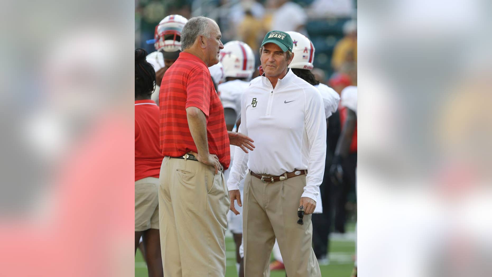 Baylor head coach Art Briles, right, and SMU head coach June Jones visit on the field before an NCAA college football game Sunday, Aug. 31, 2014, in Waco, Texas. (AP Photo/LM Otero)
