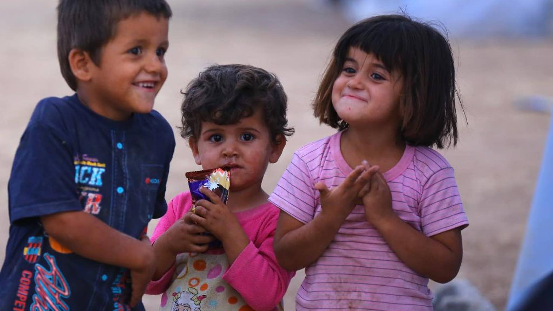 Iraqi refugees children play at Khazir refugee camp outside Irbil, 217 miles (350 kilometers) north of Baghdad, Iraq, Thursday, June 12, 2014. The Islamic State of Iraq and the Levant, the al-Qaida breakaway group, on Monday and Tuesday took over much of Mosul in Iraq and then swept into the city of Tikrit further south. An estimated half a million residents fled Mosul, the economically important city. (AP Photo)