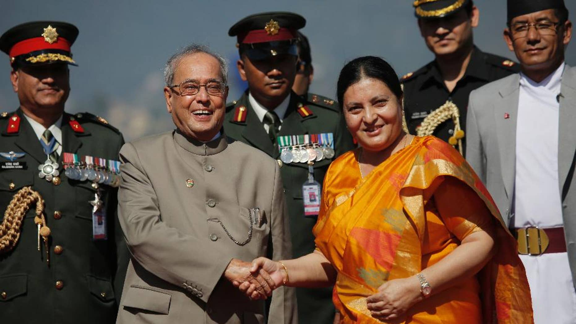 Nepalese President Bidhya Devi Bhandari, center right, shakes hand with Indian President Pranab Mukherjee on his arrival at the Tribhuwan international Airport in Kathmandu, Nepal, Wednesday, Nov. 2, 2016. Mukherjee flew to Nepal Wednesday for a three-day visit that is mostly a goodwill and pilgrimage trip to the Himalayan nation. (AP Photo/Niranjan Shrestha)
