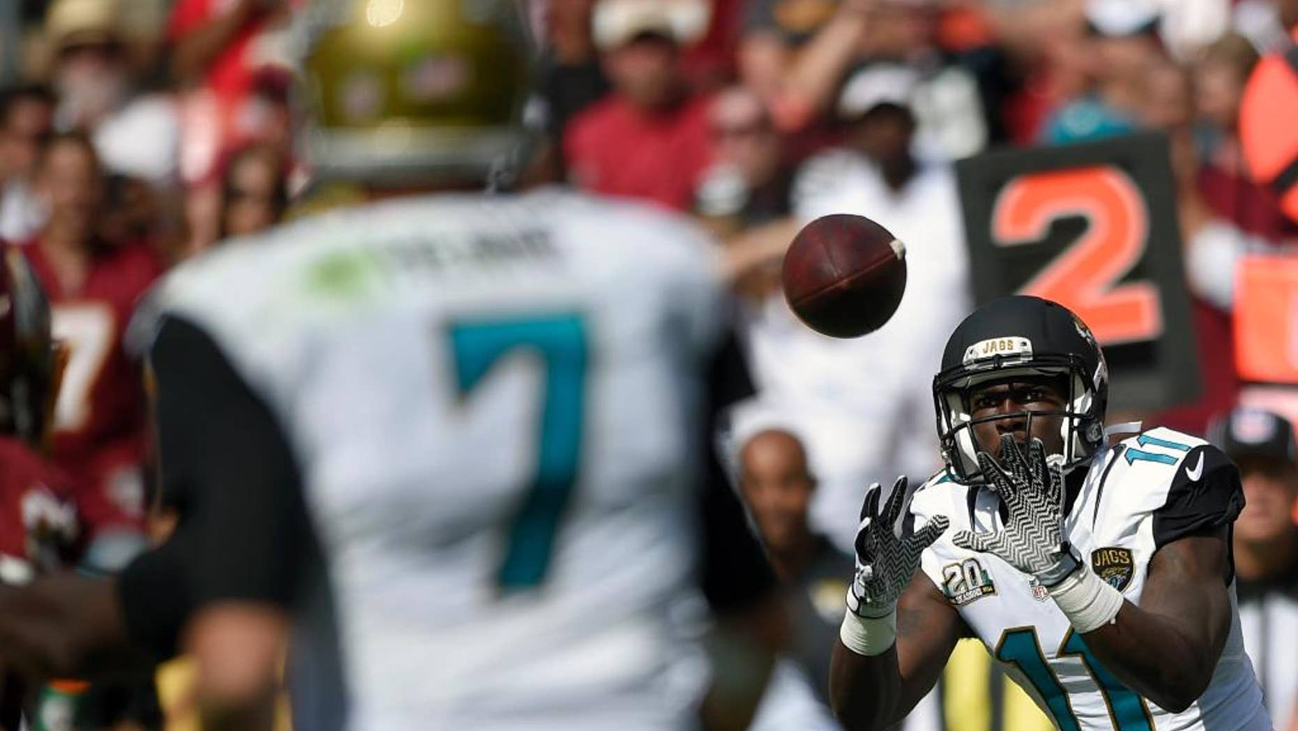 Jacksonville Jaguars wide receiver Marqise Lee (11) catches a pass from quarterback Chad Henne (7) during the second half of an NFL football game against the Washington Redskins, Sunday, Sept. 14, 2014, in Landover, Md. (AP Photo/Nick Wass)