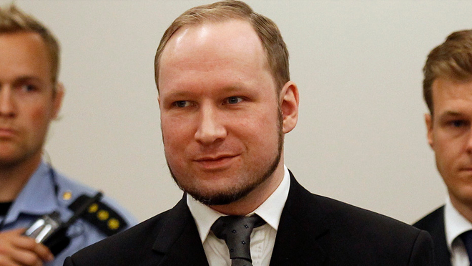 August 24, 2012: Norwegian mass killer Anders Behring Breivik smiles as he arrives at the court room in Oslo. Breivik was jailed for a maximum term on Friday when judges declared him sane enough to answer for the murder of 77 people last year, drawing a smirk of triumph from the self-styled warrior against Islam.