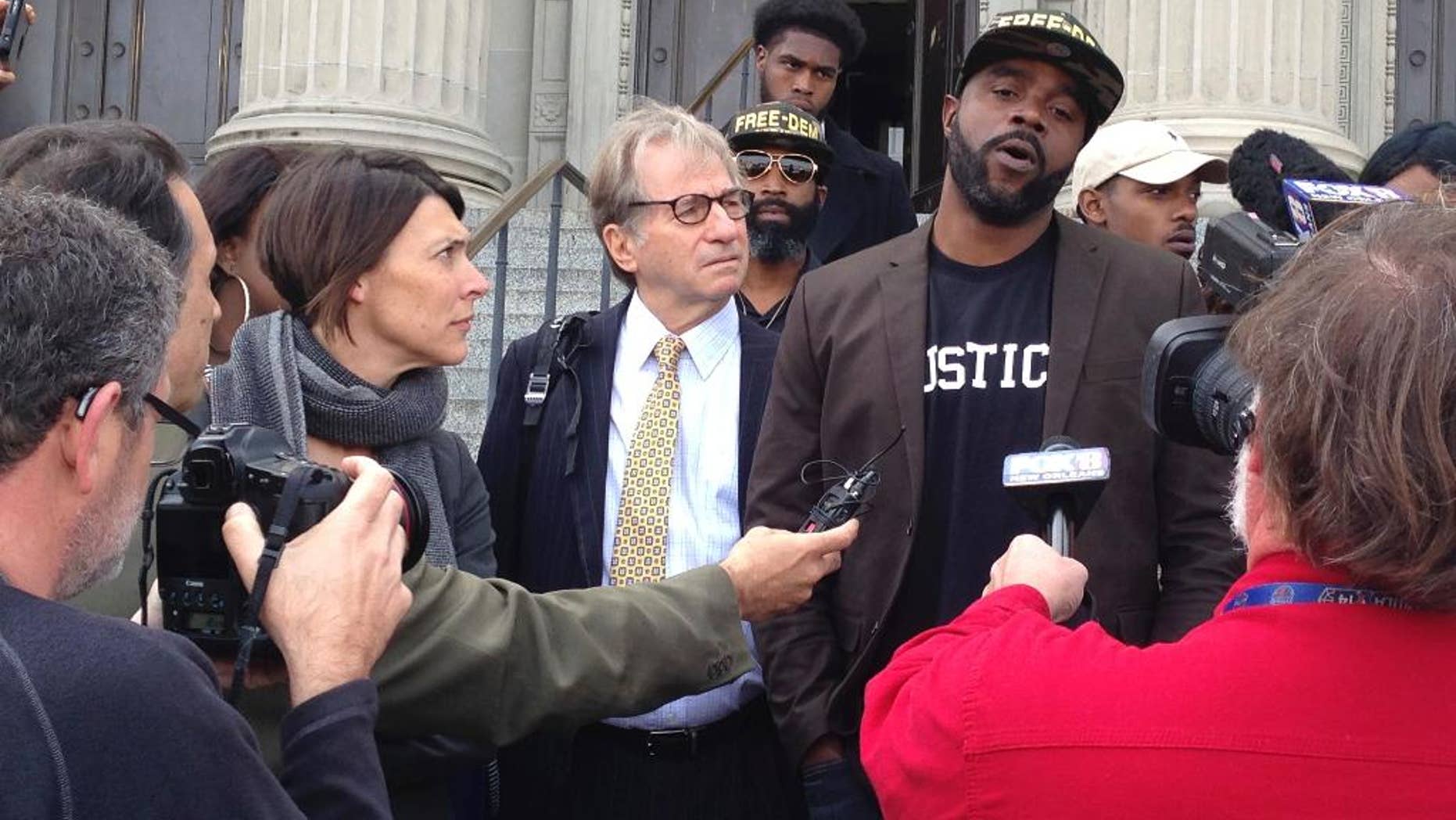 Robert Jones, right, speaks with reporters, with defense attorneys Emily Maw, left, and Barry Scheck, at the New Orleans courthouse, Thursday, Jan. 26, 2017. Prosecutors formally dropped charges Thursday against Jones who spent more than 20 years behind bars for a 1992 crime spree that included the slaying of a British tourist. (AP Photo/Kevin McGill)