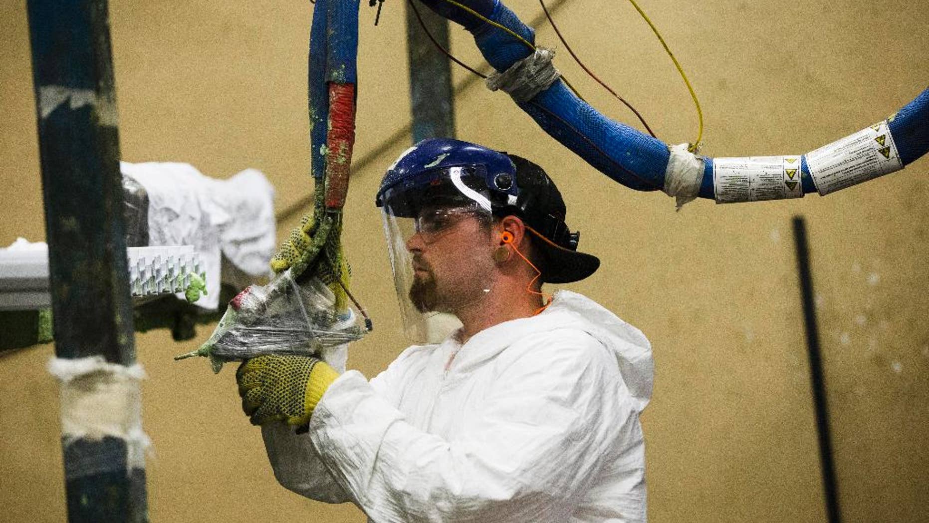FILE - In this Aug. 7, 2014 photo, a worker assembles construction supplies at Northeast Building Products in Philadelphia. The Commerce Department releases factory orders for July on Wednesday, Sept. 2, 2015. (AP Photo/Matt Rourke, File)