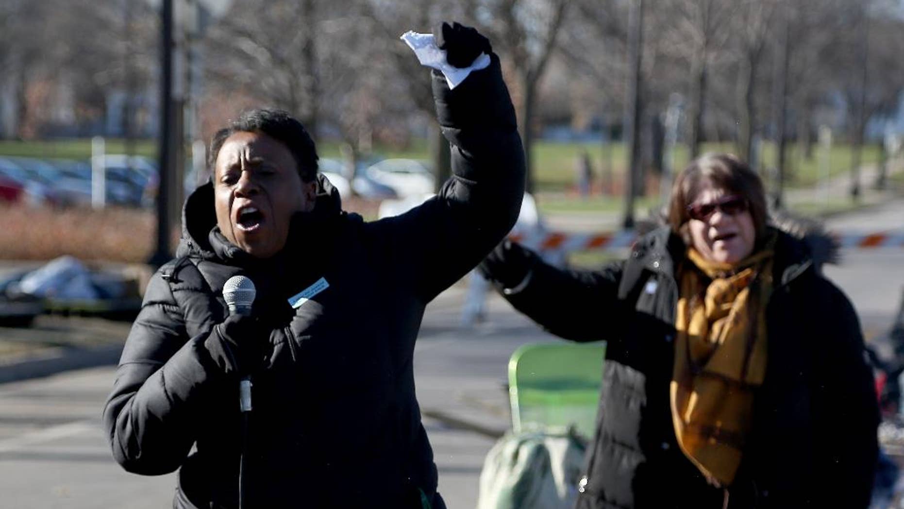 Grace Jones, of the AFSCME union, chants along with the crowd of union workers and protesters before speaking in front of a police precinct Saturday, Nov. 21, 2015, in Minneapolis. An encampment of protesters outside a Minneapolis police station vowed Saturday to maintain their vigil over the death of a black man who was shot by police, saying they won't move until video recordings of the encounter are released and authorities change how they interact with communities they serve. (Kyndell Harkness/Star Tribune via AP) MANDATORY CREDIT; ST. PAUL PIONEER PRESS OUT; MAGS OUT; TWIN CITIES LOCAL TELEVISION OUT