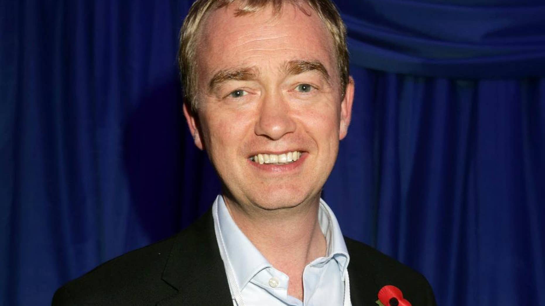 FILE - In this Thursday, Nov. 8, 2016 file photo, Liberal Democrat leader Tim Farron attends the US Embassy's election night party in central London. A British opposition party says it will vote against starting exit talks with the European Union unless the government promises a new referendum before leaving the bloc. Liberal Democrat leader Tim Farron said Friday, Nov. 11, 2016 that his party would vote against starting exit negotiations unless voters got to "have their say in a referendum on the terms of the deal" between Britain and the EU. (Yui Mok/PA via AP, File)