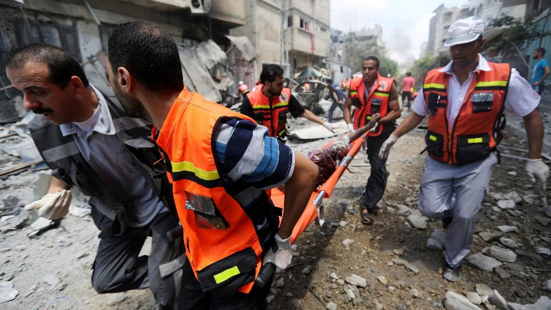 July 20, 2014: Palestinian medics carry a man injured in Gaza City's Shijaiyah neighborhood in the northern Gaza Strip of Israel.
