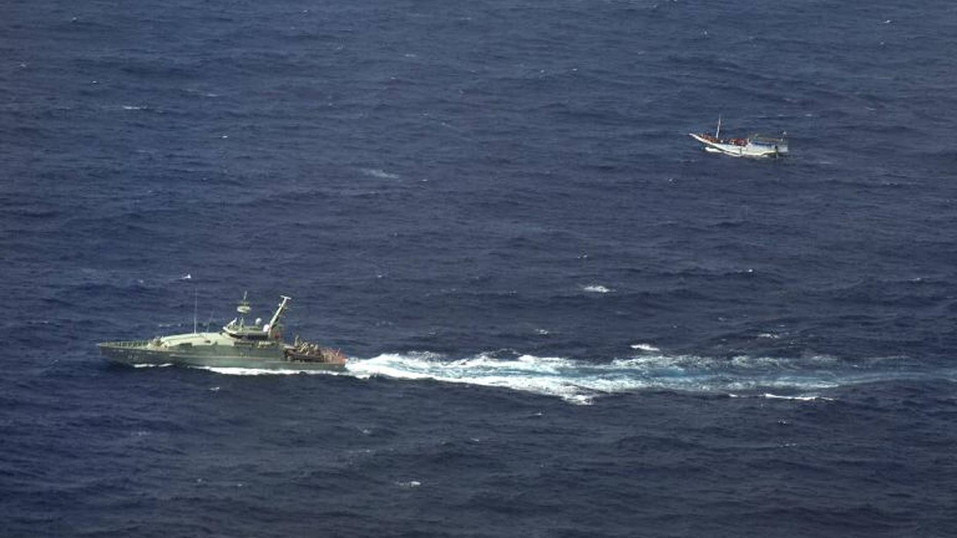 An Australian navy vessel (left) shadows a boat believed to be carrying up to 180 asylum-seekers off Indonesia, on July 4, 2012