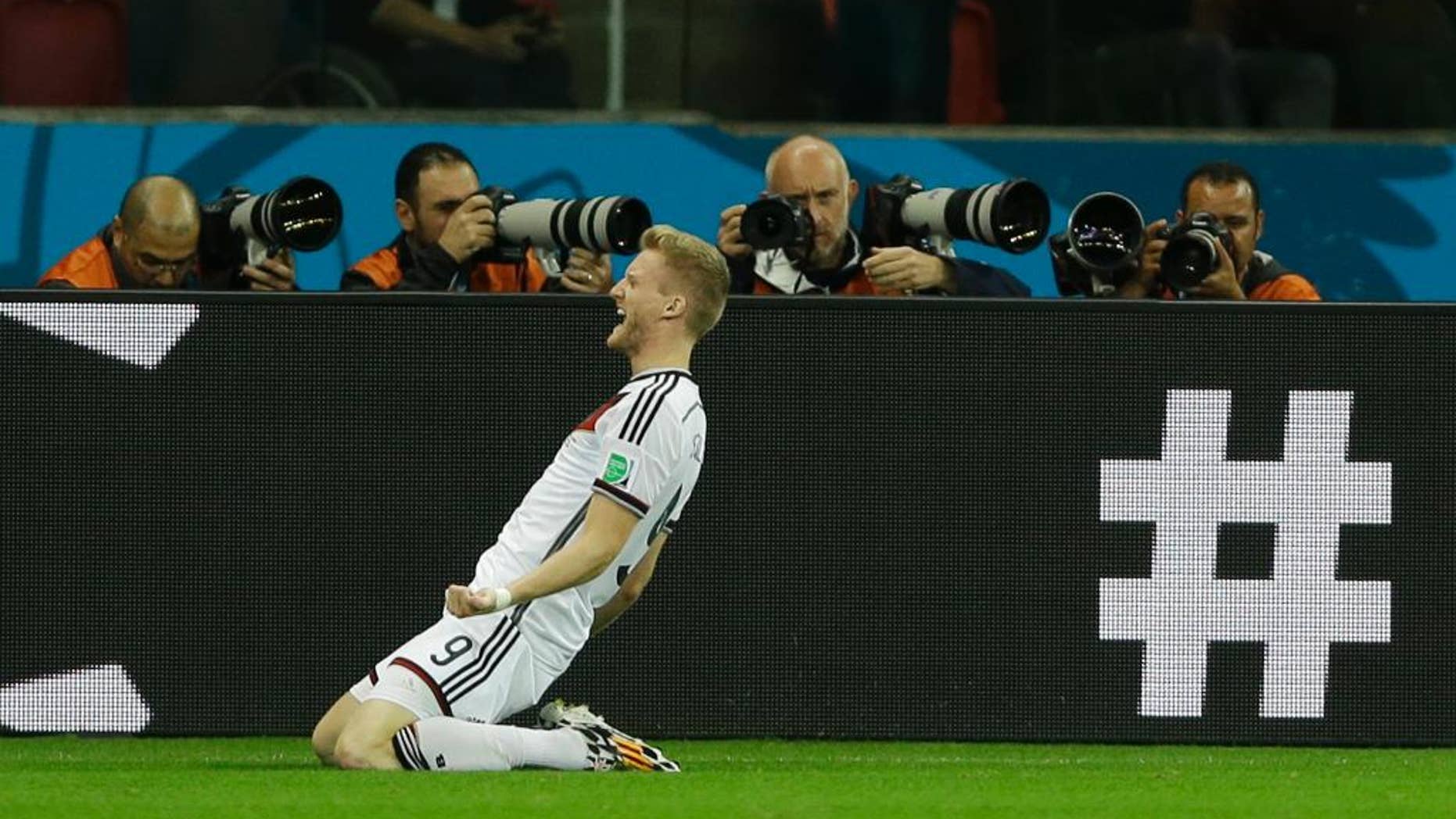 Germany's Andre Schuerrle celebrates after scoring his side's first goal in overtime during the World Cup round of 16 soccer match between Germany and Algeria at the Estadio Beira-Rio in Porto Alegre, Brazil, Monday, June 30, 2014. (AP Photo/Kirsty Wigglesworth)