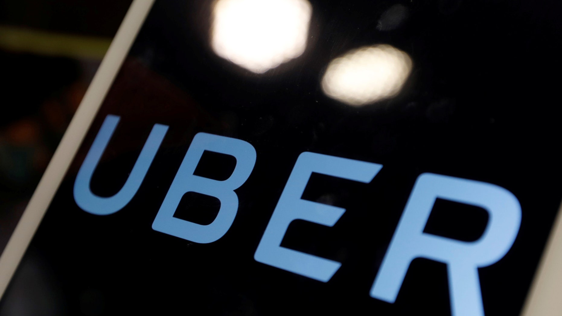 The logo of Uber is seen on an iPad, during a news conference to announce Uber resumes ride-hailing service, in Taipei, Taiwan April 13, 2017