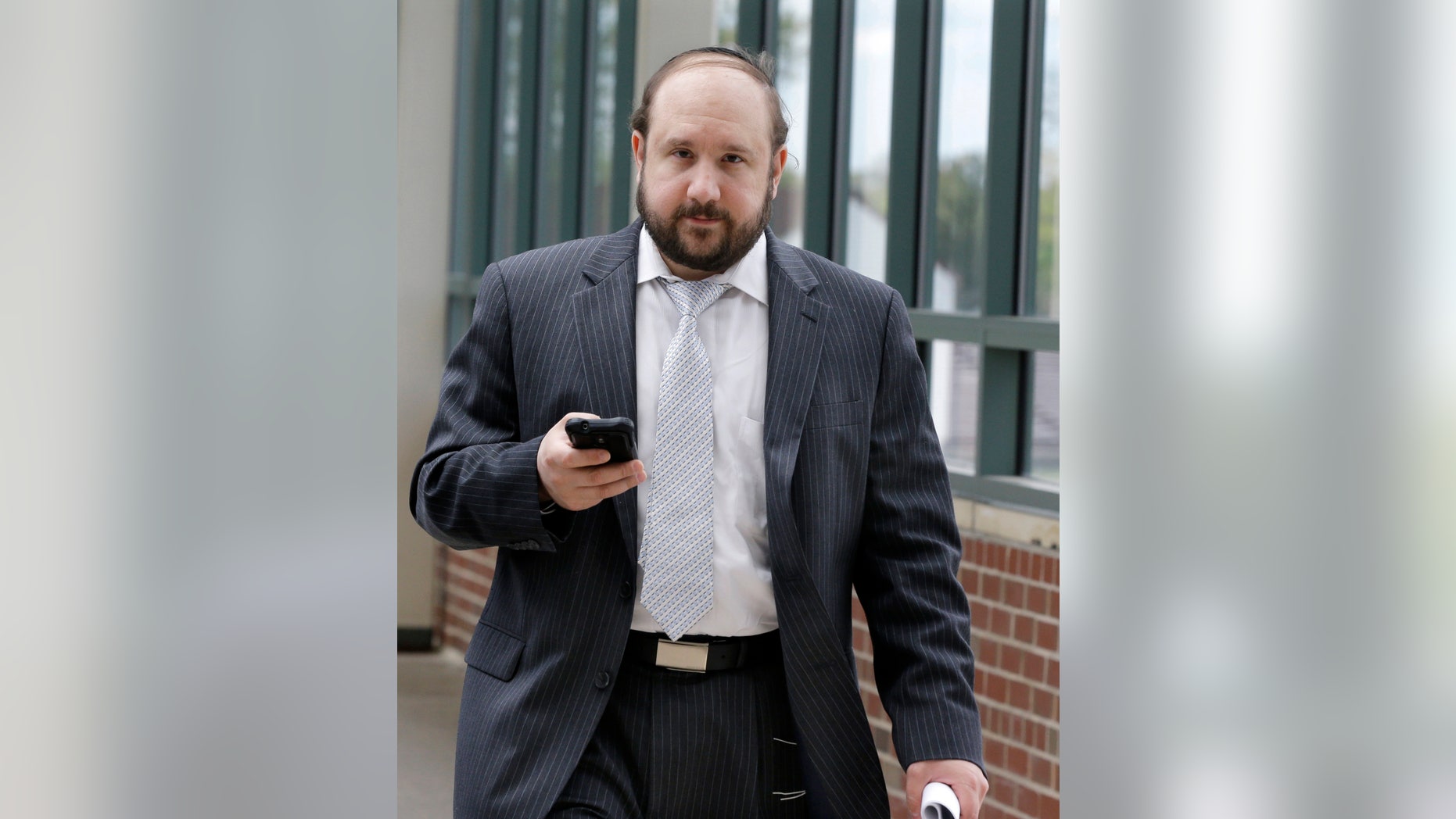 FILE - In this Thursday, May 9, 2013 file photo, Yosef Kolko, 39, walks near the Ocean County Courthouse in Toms River, N.J., during a break in his trial on sexual assault charges. Kolko pleaded guilty in May while on trial for several counts including aggravated sexual assault. The crimes allegedly involved an 11-year-old boy Kolko met at a camp in 2007. On Thursday, Oct. 17, 2013, Kolko is scheduled to appear in court to try and withdraw his plea, claiming he was pressured by members of his Orthodox Jewish community to plead guilty to sexually abusing a child. (AP Photo/Mel Evans, File)