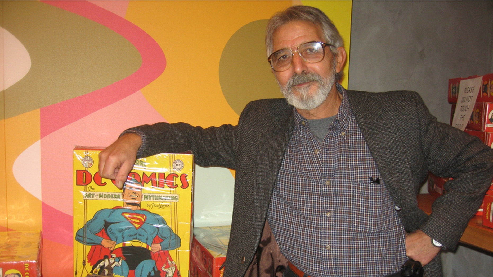 Comic book artist José Luís García-López with the supersized, Eisner-winning "75 Years of DC Comics: The Art of Modern Mythmaking"
