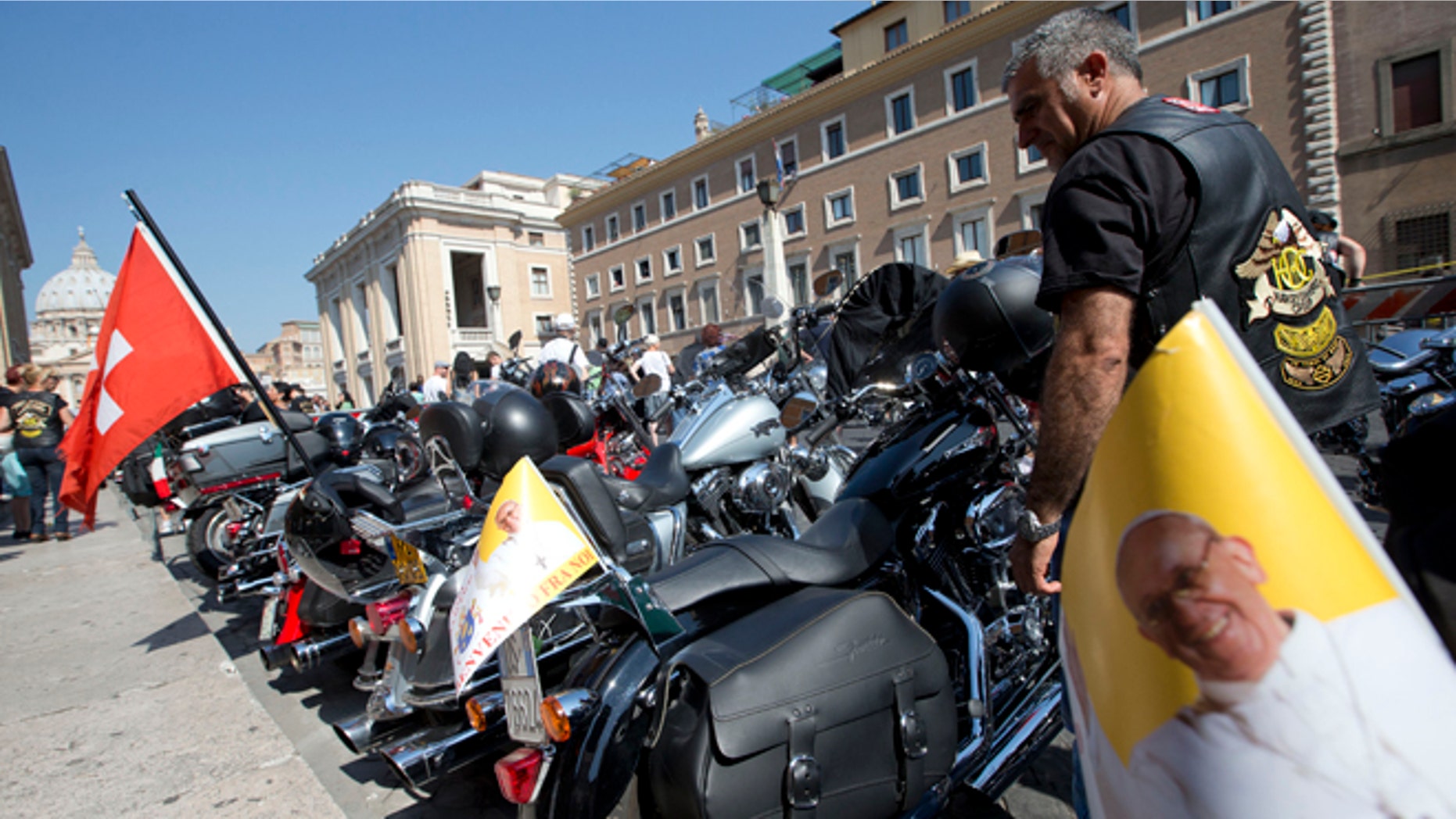 Harley Davidson motorcycles riders park their motorcycles in Via della Conciliazione leading to the Vatican, seen at left, as they wait for Pope Francis to drive by to bless them ahead of mass in St. Peter's Square, at the Vatican, Sunday, June 16, 2013. The riders are gathered in Rome for a four-day event to celebrate the motorcycle company's 110th anniversary. (AP Photo/Andrew Medichini)