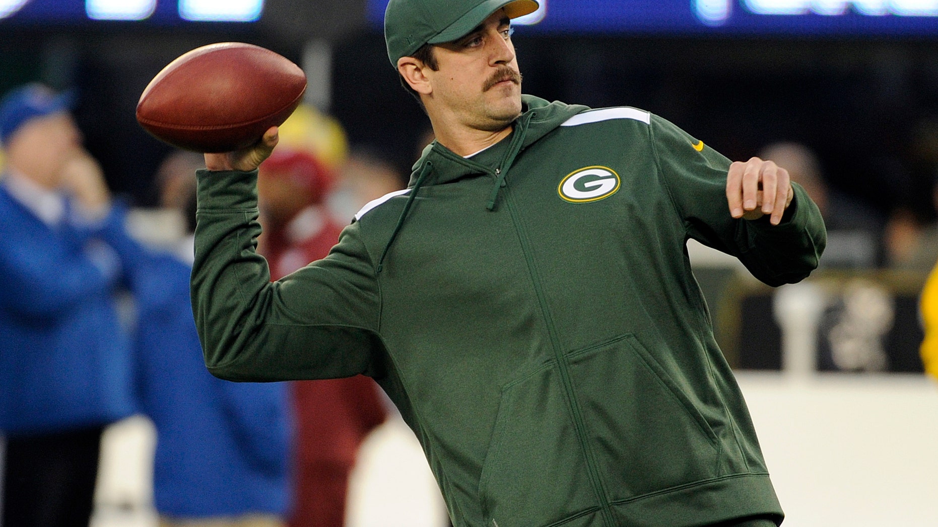 Green Bay Packers quarterback Aaron Rodgers throws a pass as his team warms up before an NFL football game against the New York Giants, Sunday, Nov. 17, 2013, in East Rutherford, N.J. (AP Photo/Bill Kostroun)