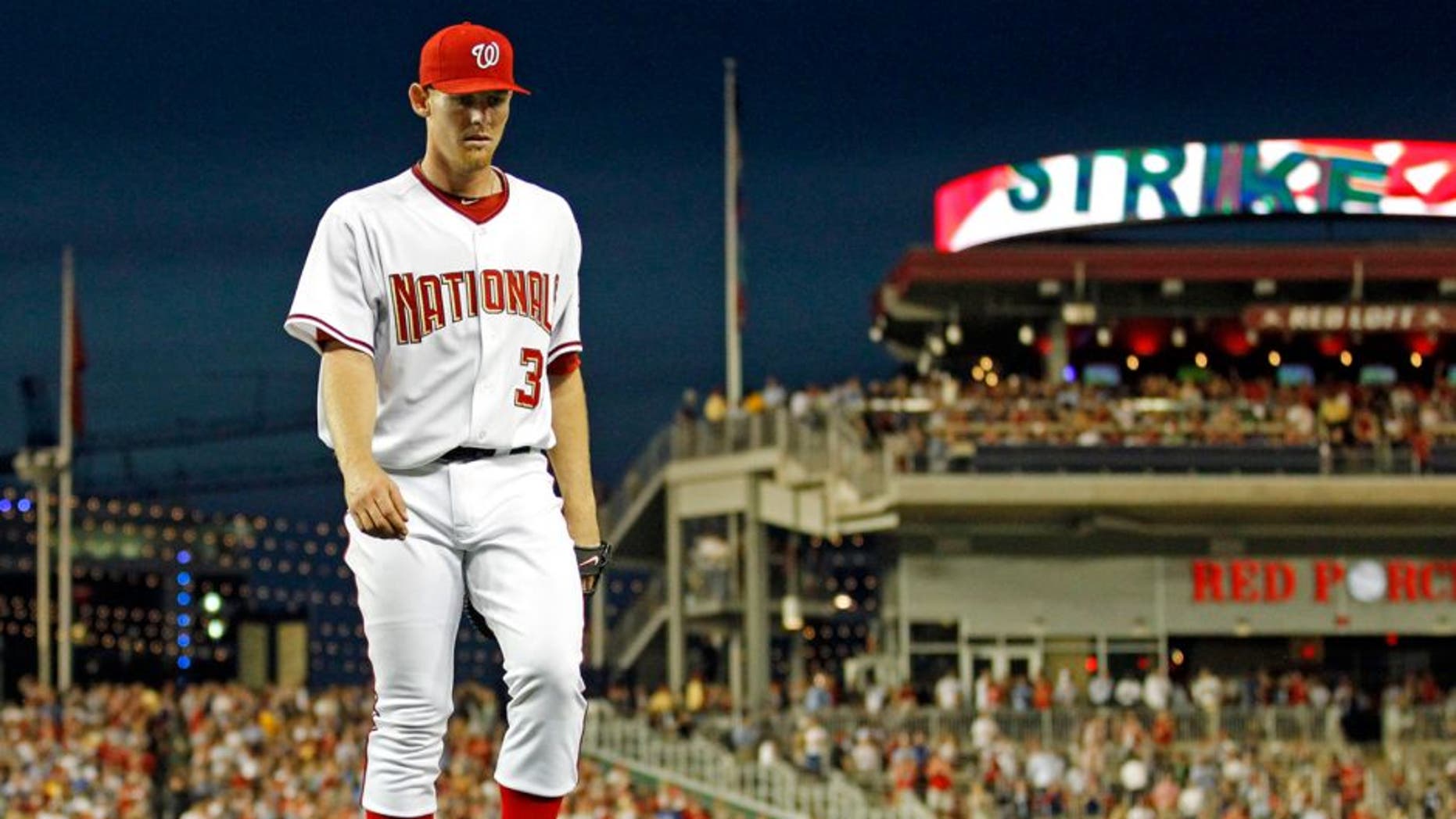 Washington Nationals starting pitcher Stephen Strasburg walks off the field in the seventh inning after 14 strikeouts in his major league debut in a baseball game against the Pittsburgh Pirates in Washington, Tuesday, June 8, 2010. (AP Photo/Manuel Balce Ceneta)