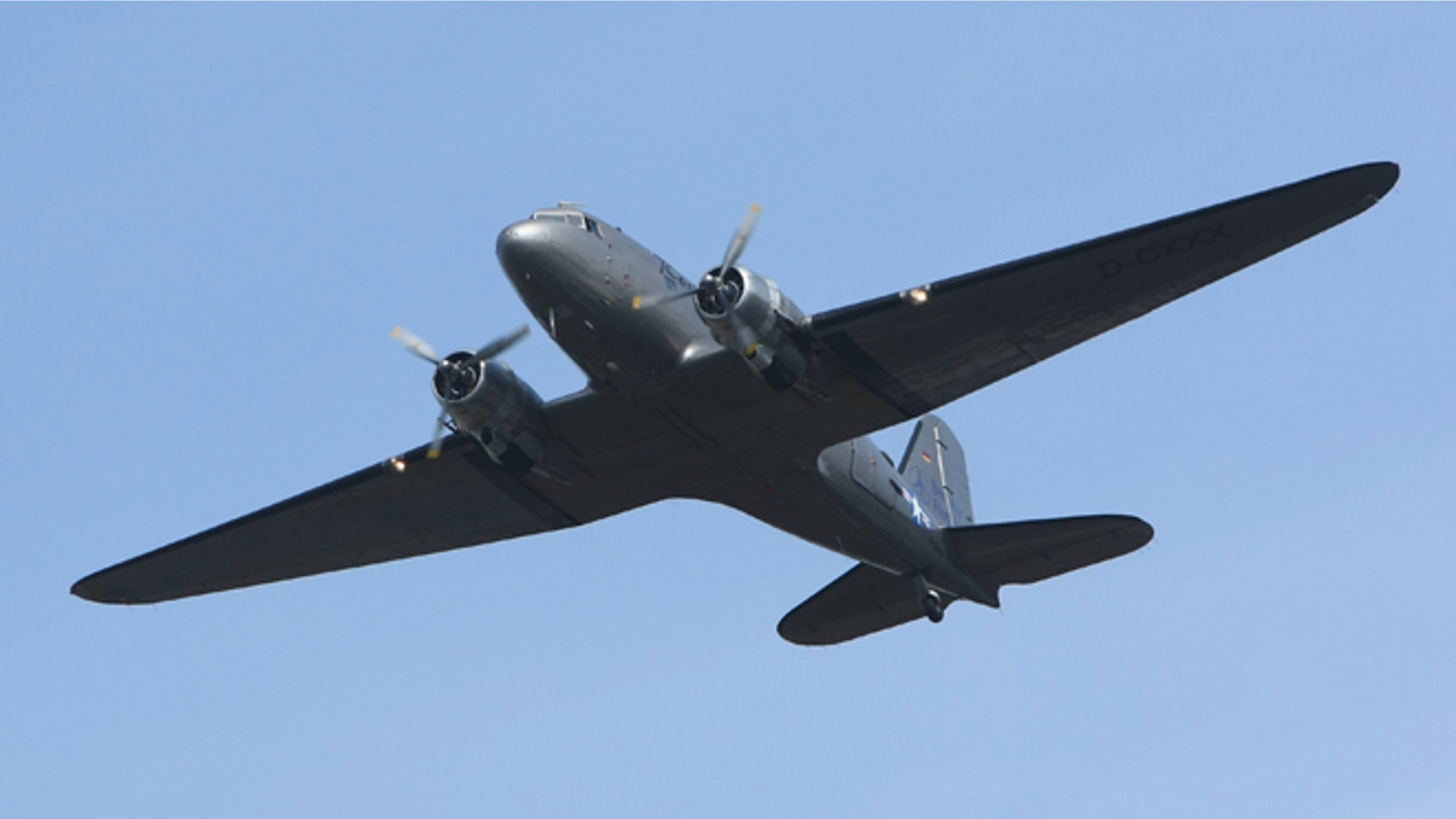 BERLIN - SEPTEMBER 02: A historic DC-3 airplane, also known as the Rosinenbomber, or Raisin Bomber, flies near Tempelhof Airport September 2, 2008 in Berlin, Germany. The Rosinenbomber flies tourists over Berlin and commemorates the Allied bombers that hauled supplies to Berlin during the Berlin Airlift in 1948, when the Soviet military blockaded the city. The Rosinenbomber flights from Temepelhof will end on October 30, 2008, on the last day of operation of Tempelhof. The airport, located in the city center, will close after approximately 70 years of operation. (Photo by Sean Gallup/Getty Images)