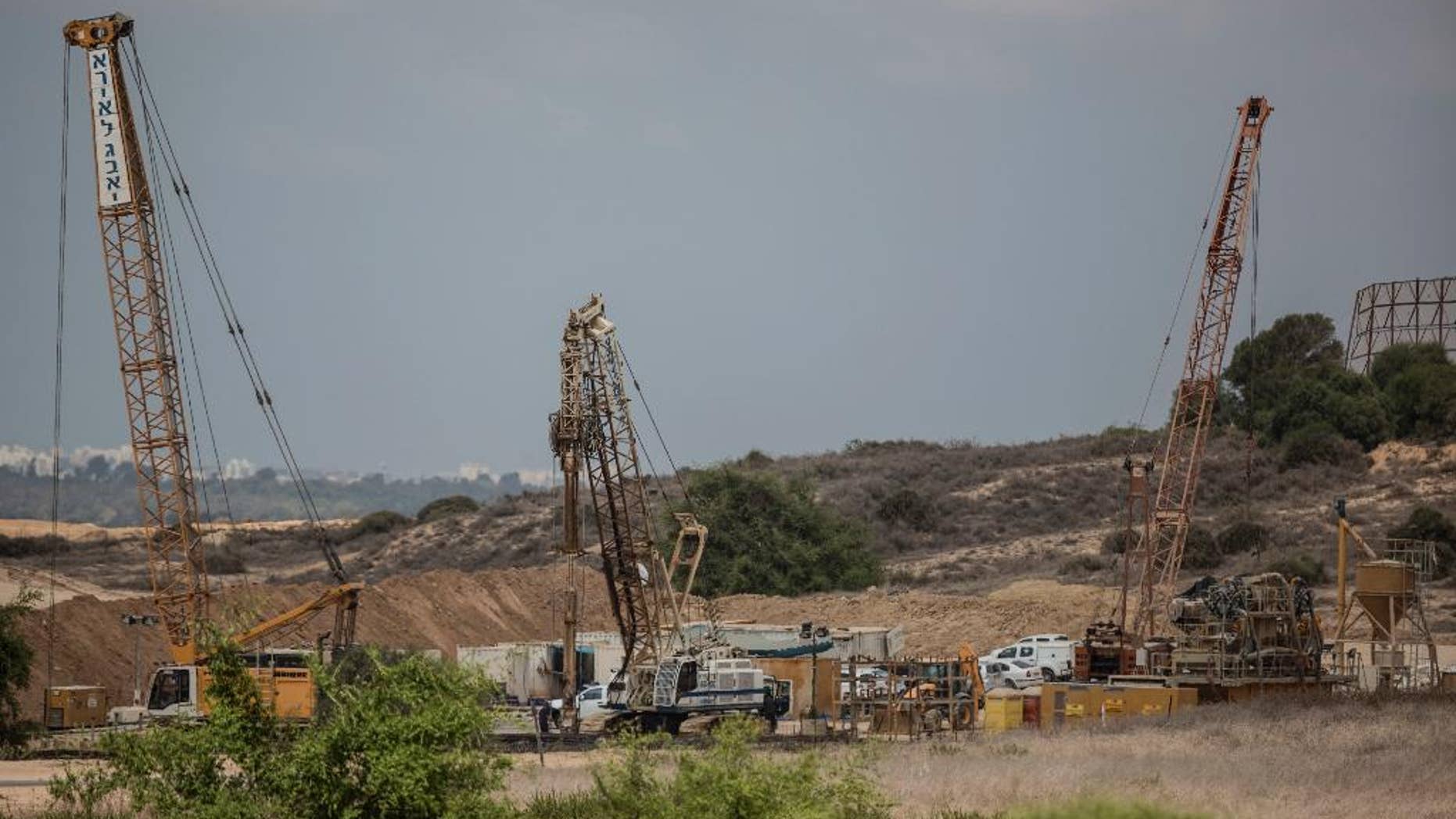 FILE -- In this Thursday, Sept. 8, 2016 file photo, heavy machinery works on a massive underground barrier on the Israeli side of the border with Gaza. On Sunday, Sept. 25, 2016, an Israeli Southern Command official said the barrier being built along the Gaza border to defend against Hamas tunnels should be completed in a matter of months, dealing what he said would be a serious blow to the Islamic militant group. Mushir al-Masri, a Hamas official in Gaza, said the Israeli efforts would fail. (AP Photo/Tsafrir Abayov, File)