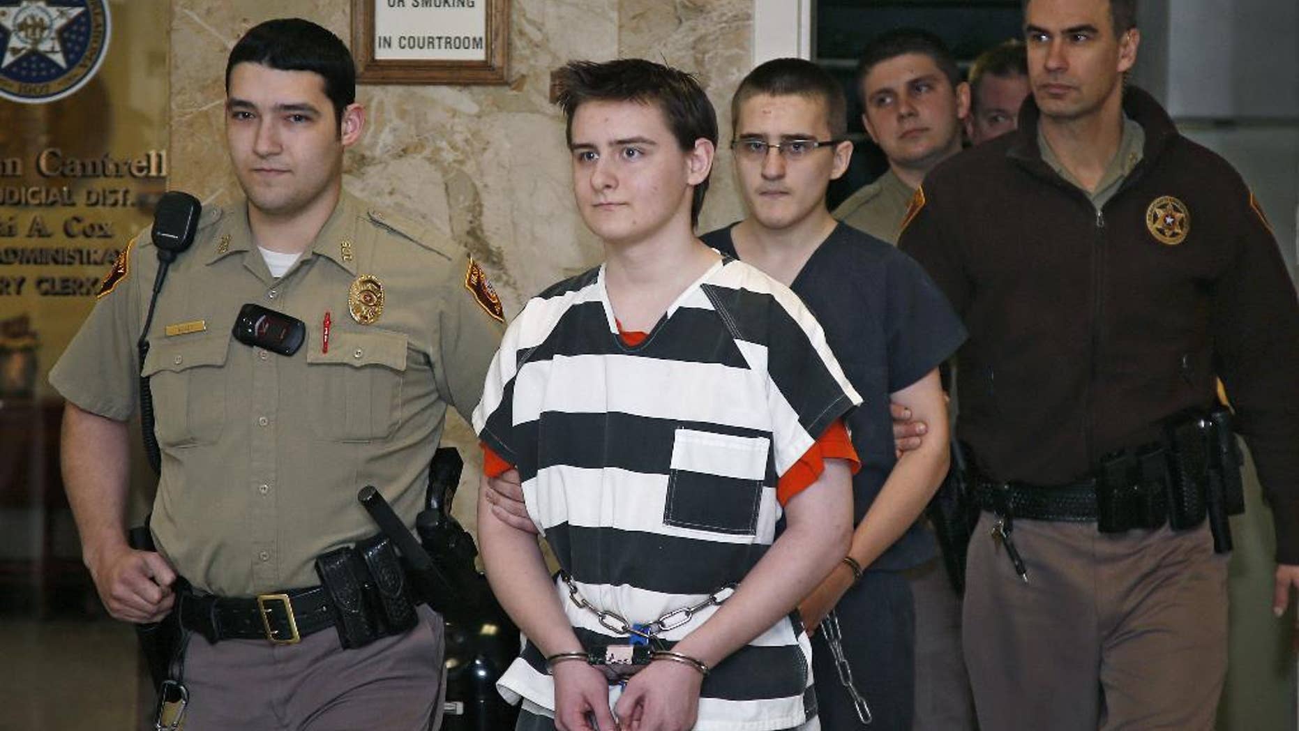 FILE- In this Tuesday, Feb. 23, 2016 file photo, Robert Bever, second from left, and Michael Bever, third from left, are escorted into a courtroom for a hearing in Tulsa, Okla. The two Oklahoma teenage brothers are charged with fatally stabbing their parents and three of their younger siblings. Robert Bever, the elder of the two, has been sentenced to life without parole after pleading guilty in the killings. (AP Photo/Sue Ogrocki, File)
