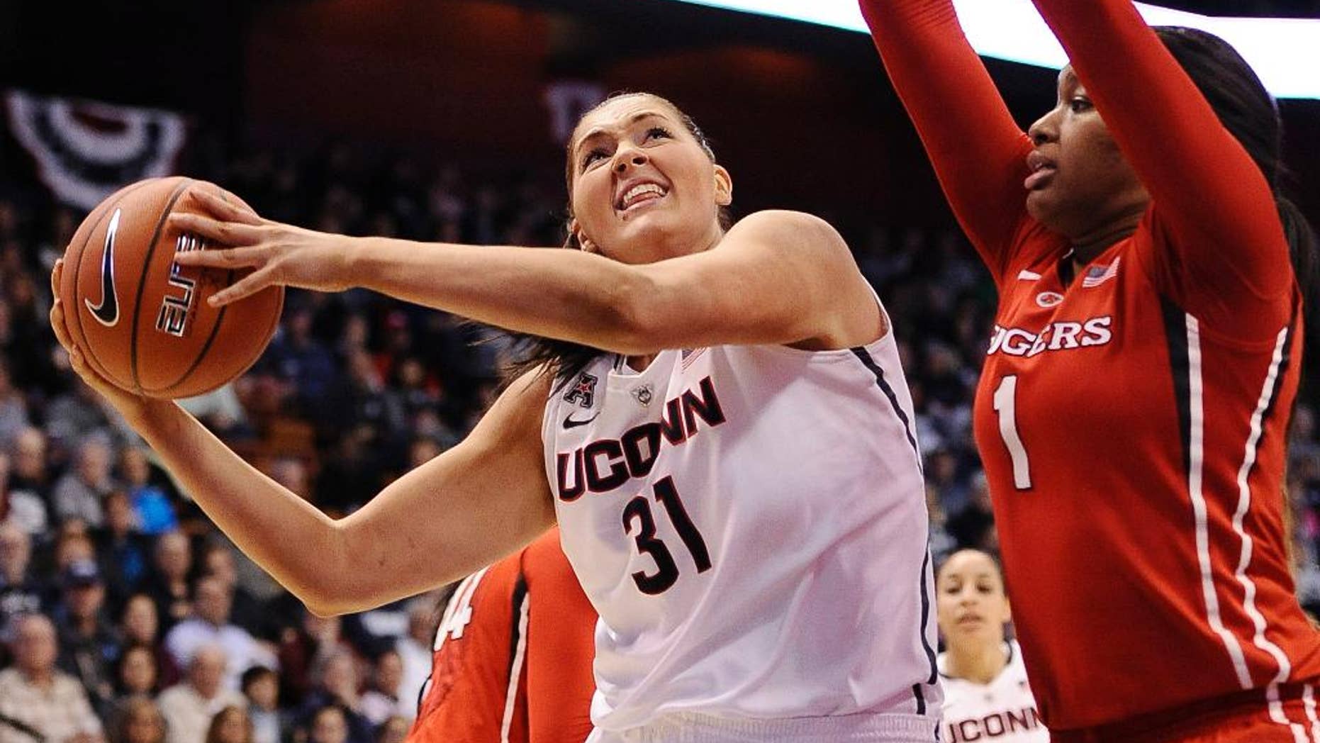 Connecticut's Stefanie Dolson (3) looks to shoot as Rutgers Rachel Hollivay, right, defends during the second half of an NCAA college basketball game in the semifinals of the American Athletic Conference women's tournament on Sunday, March 9, 2014, in Uncasville, Conn. Connecticut won 83-57. (AP Photo/Jessica Hill)