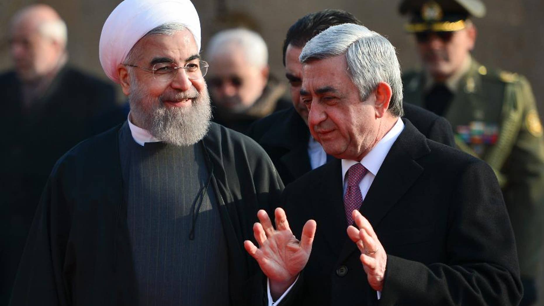 Armenian President Serzh Sargsyan, right, gestures while speaking to Iranian President Hassan Rouhani, during an official welcome ceremony at the Presidential Palace in Yerevan, Armenia, Wednesday, Dec. 21, 2016. Rouhani began his 3-day tour to Armenia, Kazakhstan and Kyrgyzstan on bilateral ties and regional developments. (Davit Hakobyan, PAN Photo via AP)