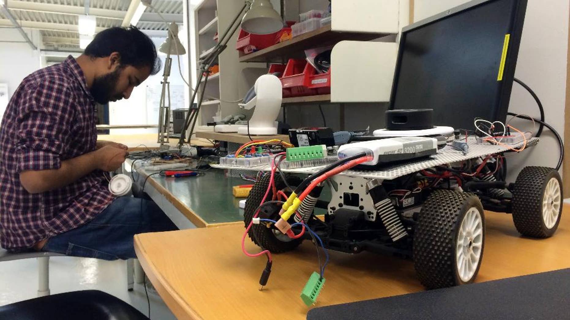 In this Monday, March 13, 2017 photo, a Uniti employee works on prototype steering controls, at the startup’s temporary production facility in Lund, Sweden. A group of Swedish students that raised 1.2 million euros in crowdfunding for their startup to build electric cars has caught the attention of German industrial heavyweight Siemens. The two sides said Wednesday that they were starting a partnership that will see them create 50,000 lightweight city cars a year starting next year. (AP Photo/James Brooks)