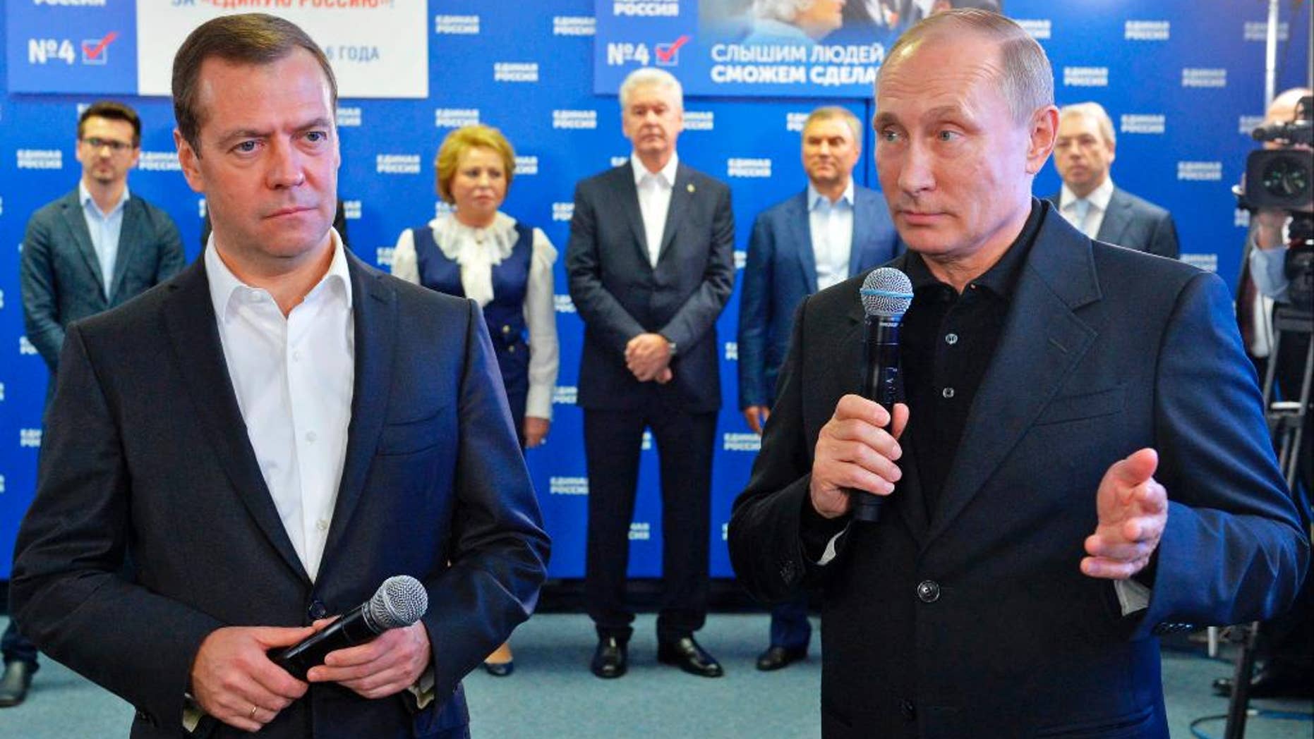 Russian President Vladimir Putin, right, and Russian Prime Minister Dmitry Medvedev, left, on Sunday.