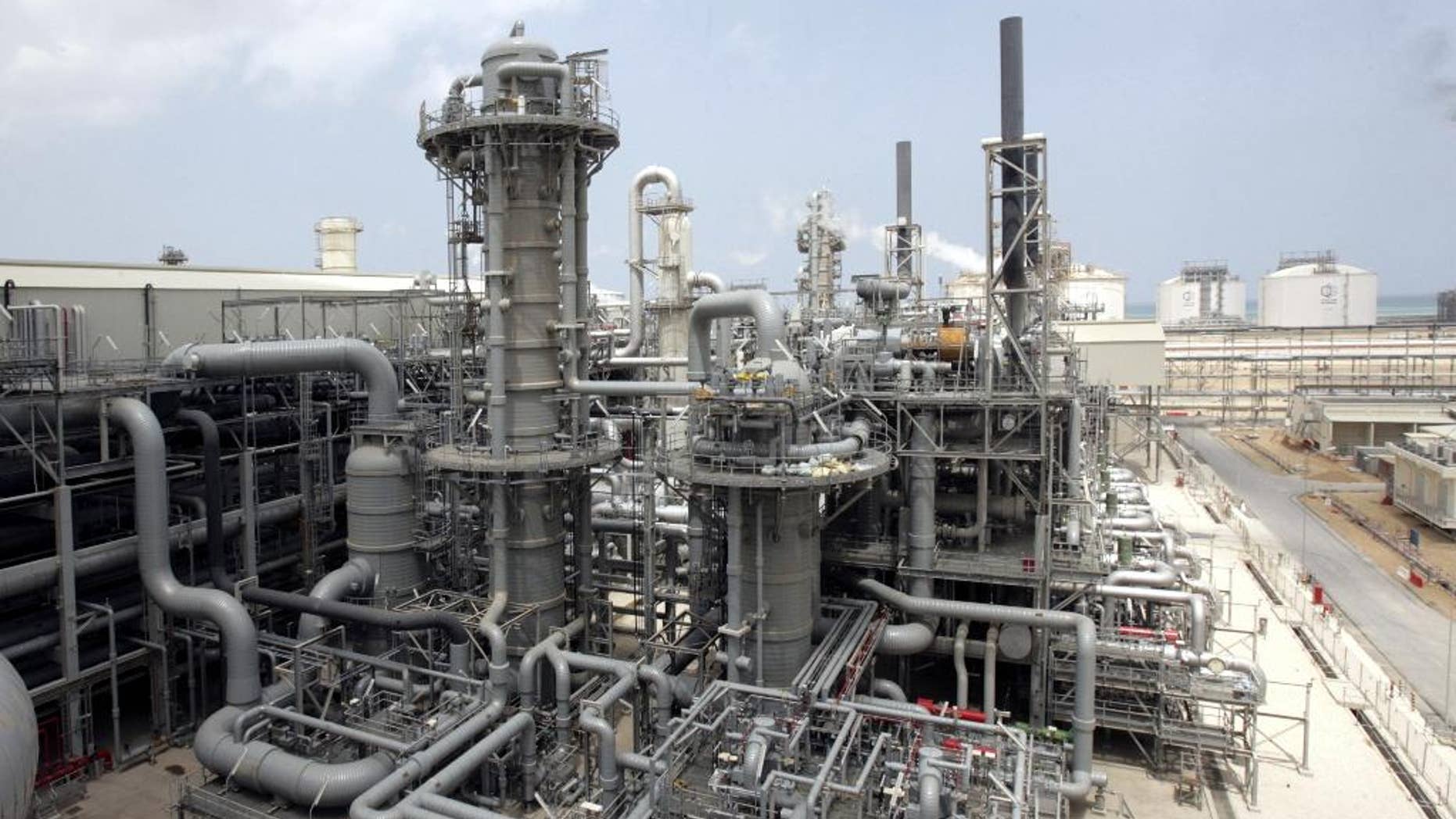 In this Saturday, April 4, 2009 file photo a gas production facility is seen in at Ras Laffan, Qatar. Qatar is merging its two government-backed liquefied natural gas companies, streamlining distribution of the fuel as the OPEC nation weathers a slump in energy prices. The Gulf country is the world’s largest producer of LNG, which is natural gas chilled to liquid form for shipment on tanker ships to customers around the world. (AP Photos/Maneesh Bakshi, File)