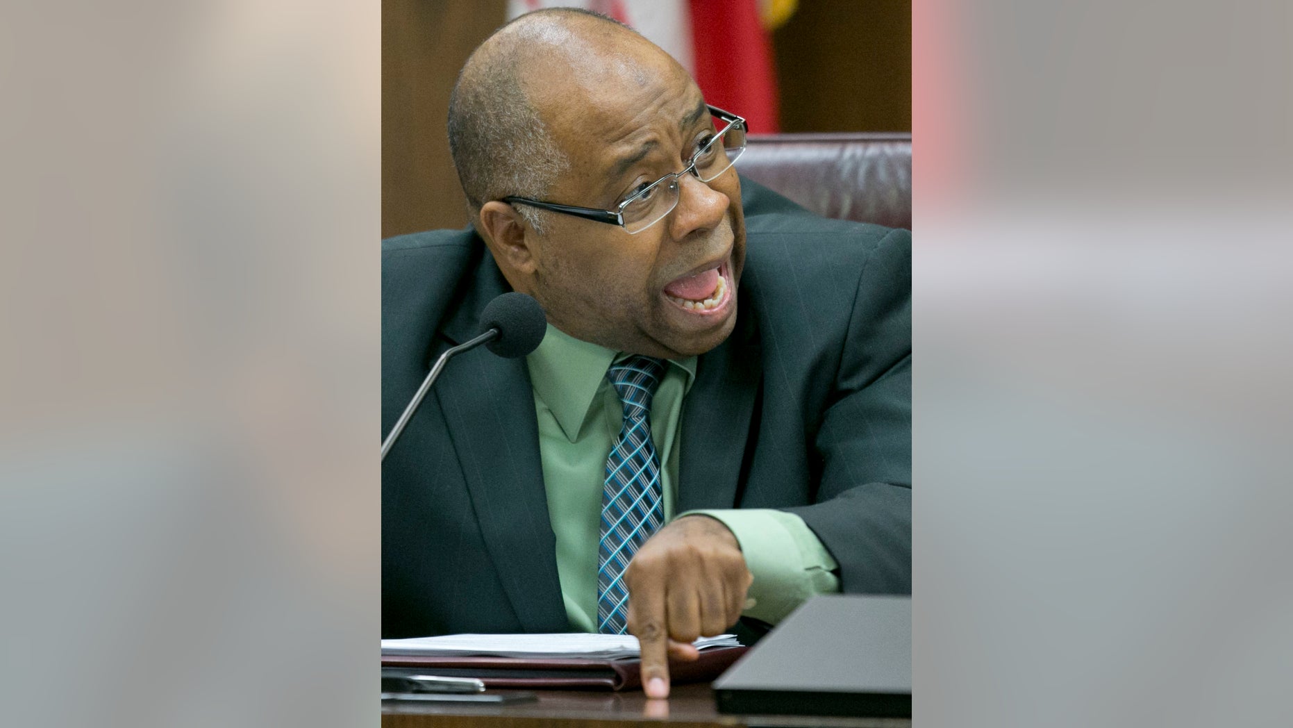 In this Thursday, Nov. 21, 2013 photo, Clarence Carter, director of Arizona's Child Protective Services (CPS), shares what Gov. Jan Brewer's reaction was when he told her that CPS missed investigating 6,000 child abuse cases, during a discussion with the Arizona Child Protective Services (CPS) oversight committee, in Phoenix. The revelation that about 6,000 cases of suspected child abuse reported to the state's CPS hotline were never investigated has cast a disturbing spotlight on a state department in disarray as officials call for investigations and accountability. (AP Photo/The Arizona Republic, Pat Shannahan)
