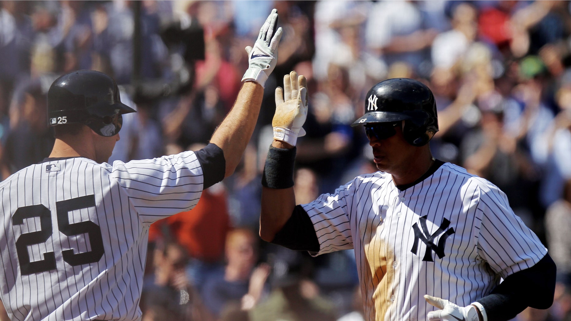 NEW YORK, NY - APRIL 13: Alex Rodriguez #13 of the New York Yankees celebrates with teammate Mark Teixeira #25 of the New York Yankees after hitting a solo home run in the third inning against the Los Angeles Angels during the home opener at Yankee Stadium on April 13, 2012 in the Bronx borough of New York City. (Photo by Nick Laham/Getty Images)