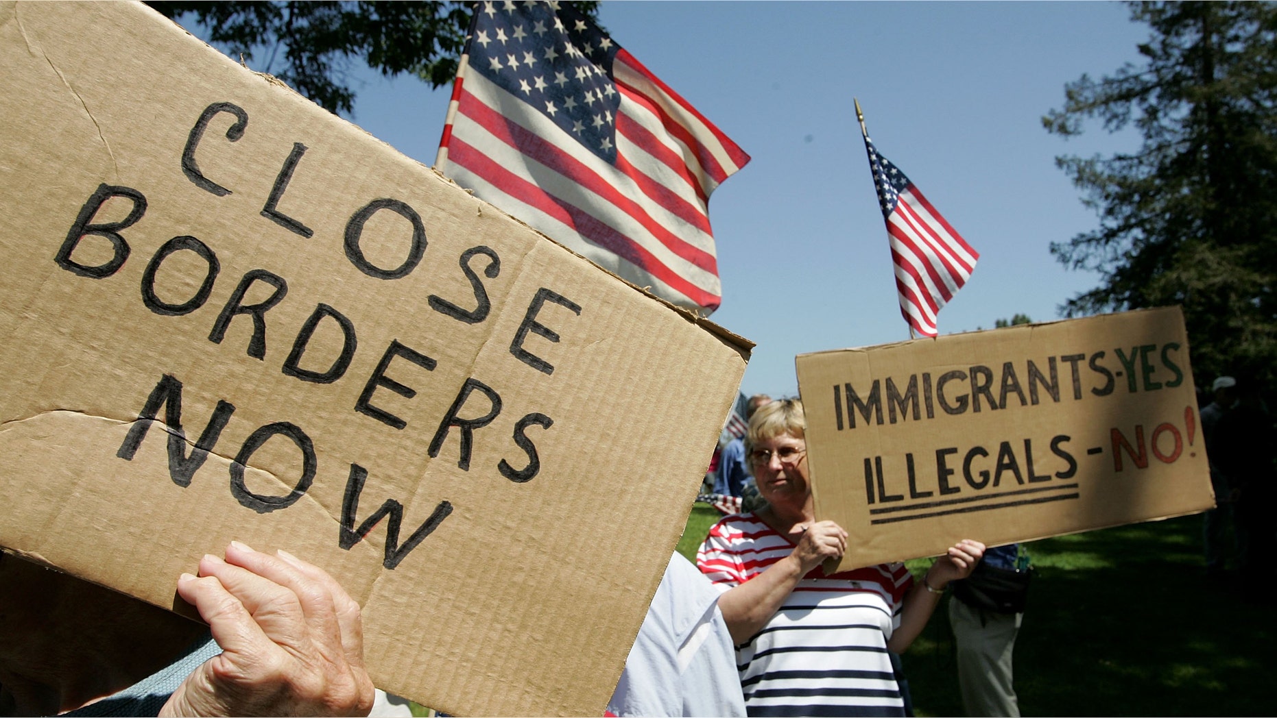 SANTA CLARA, CA - MAY 05: Anti-immigration demonstrators hold signs and American flags during an anti-immigration rally May 5, 2006 in Santa Clara, California. Dozens of anti-immigration demonstrators held a rally as similar rallies were held across the country on Cinco de Mayo to protest illegal immigrants. (Photo by Justin Sullivan/Getty Images)