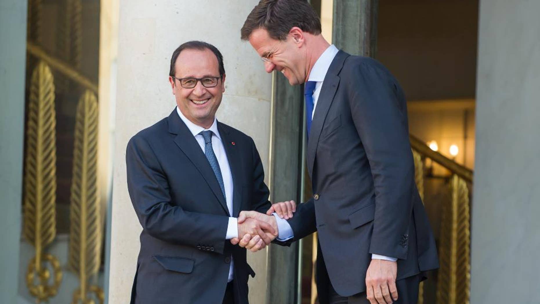 French President Francois Hollande, left shakes hands with Dutch Prime Minister Mark Rutte after their meeting at the Elysee Palace in Paris, France, Wednesday, June 3, 2015.(AP Photo/Kamil Zihnioglu)
