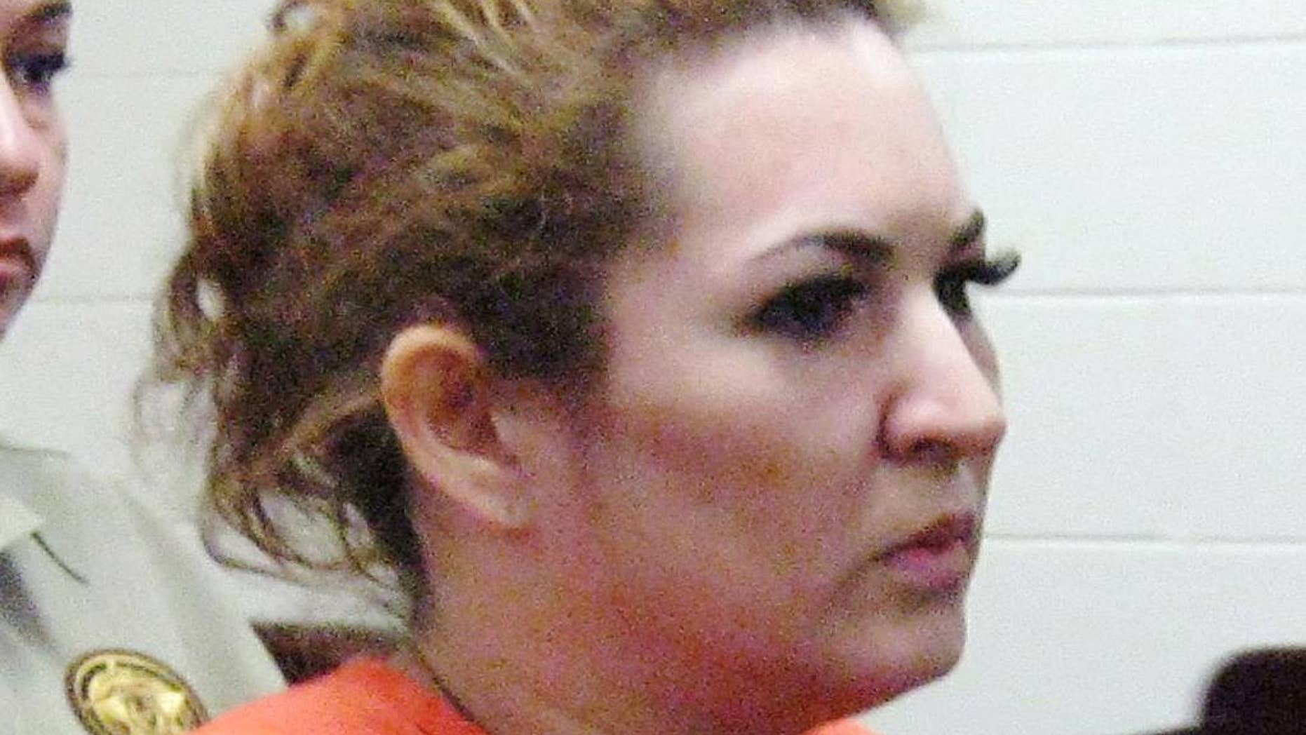 FILE - In this Nov. 26, 2013, file photo, Elva Navarro faces a justice of the peace at the Hidalgo County Jail in Edinburg, Texas. The South Texas woman was sentenced in December 2014 to three years in prison for the death of a customer injected with liquid silicone at the woman’s spa. The recent death of a Dallas woman who received illegal buttocks injections follows other fatal black-market procedures that highlight the popularity of cosmetic surgery. (AP Photo/The McAllen Monitor, Ildefonso Ortiz, File)