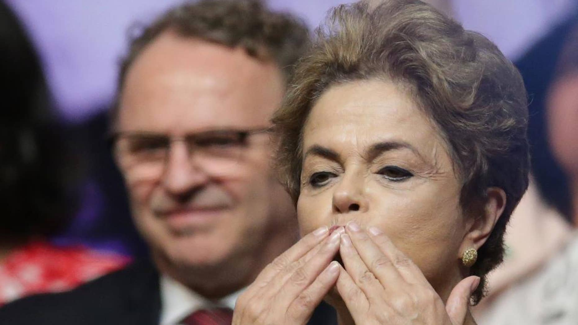 Brazil's President Dilma Rousseff blows kisses during the opening of the National Conference of Women, in Brasilia, Brazil, Tuesday, May 10, 2016. The impeachment proceedings against Rousseff took another hairpin turn Tuesday after the acting speaker of Congress' lower house Waldir Maranhao put the impeachment process back on track a day after he sparked chaos and sowed further discord among Brazil's fractious political class by annulling an April 17 vote by the Chamber of Deputies for impeachment. (AP Photo/Eraldo Peres)