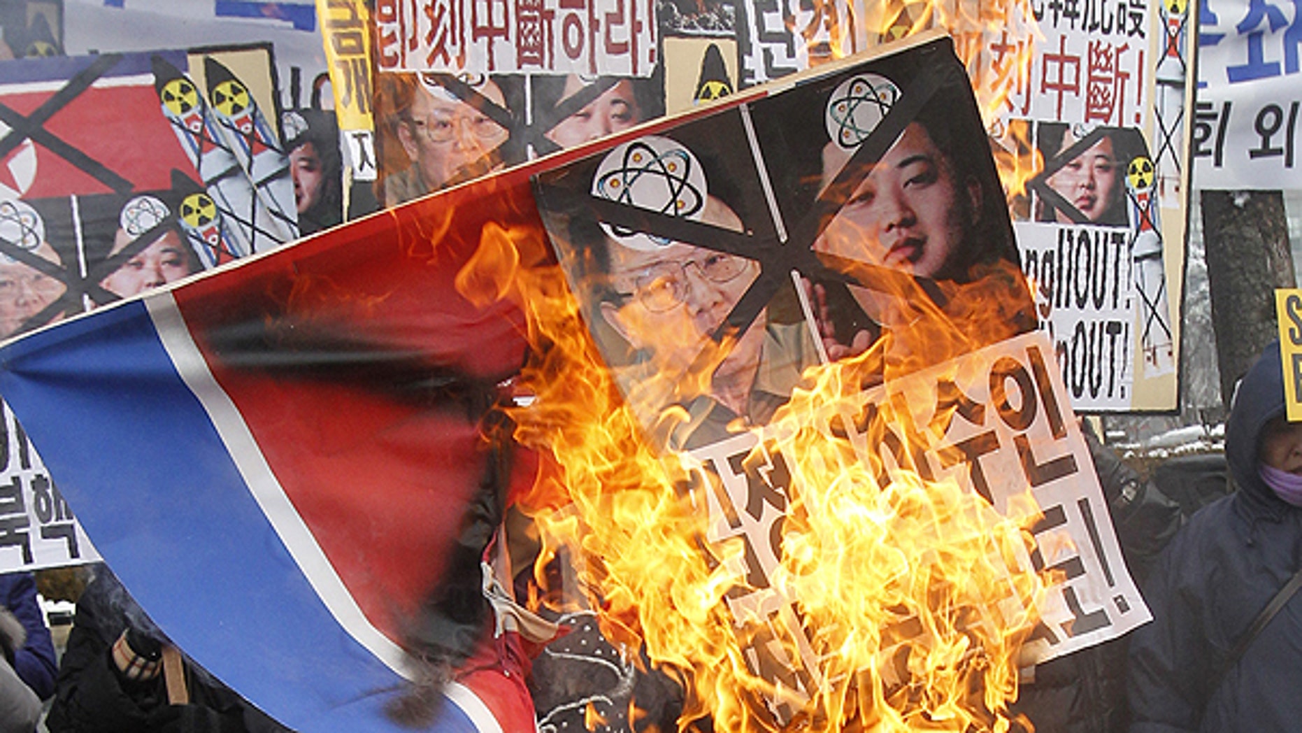 Dec. 28: Anti-North Korea protesters burn a North Korea flag and pictures of North Korean leader Kim Jong Il and his youngest son Kim Jong Un during a rally in Seoul, South Korea.