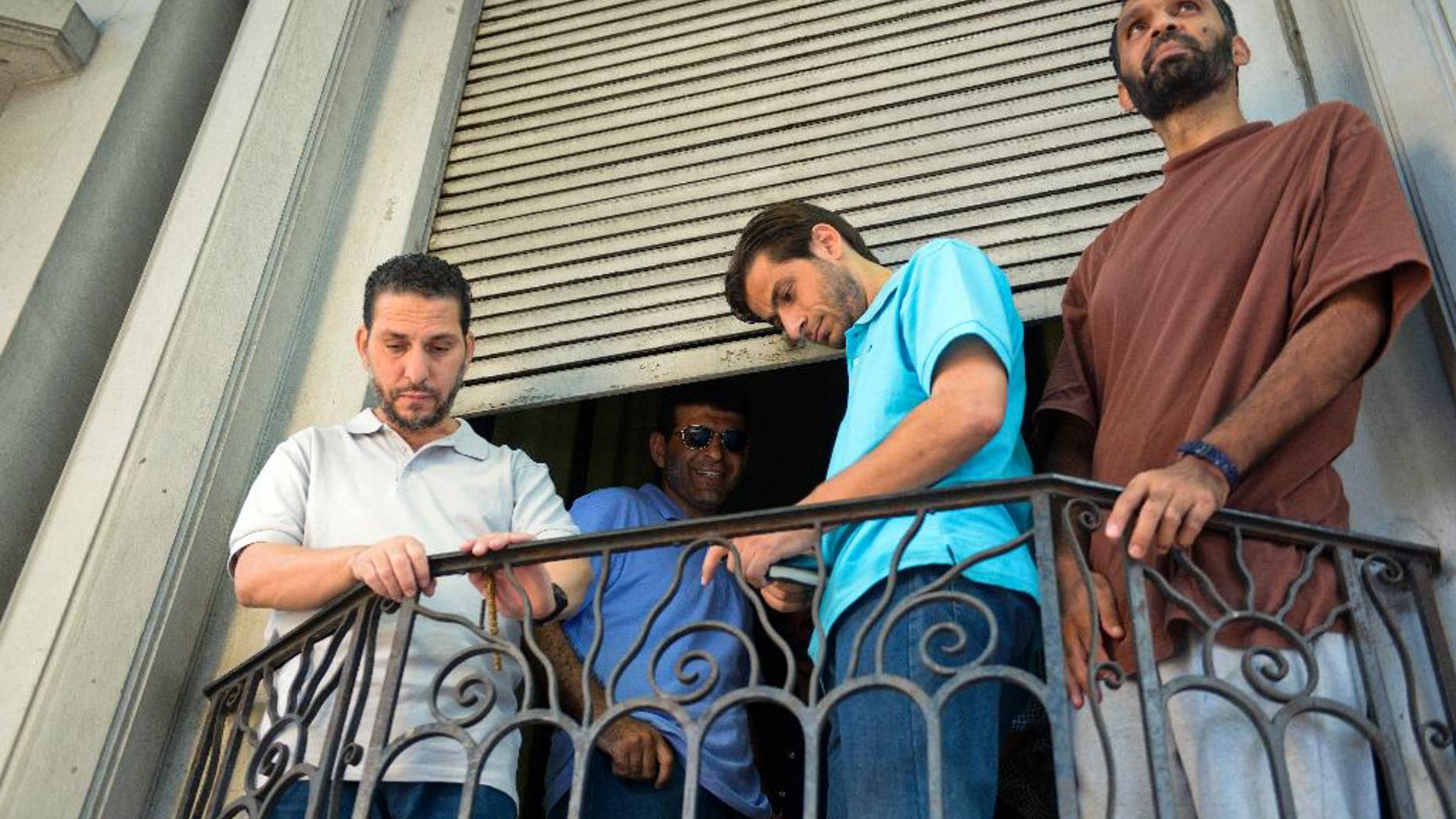 FILE - In this Dec. 12, 2014 file photo, former Guantanamo prisoners, from left, Adel bin Muhammad El Ouerghi from Tunisia, Ali Husain Shaaban from Syria, Ahmed Adnan Ajuri from Syria, and Palestinian Mohammed Abdullah Taha Mattan interact with journalists outside their temporary home in Montevideo, Uruguay. The men are four of six former prisoners who were held for 12 years at Guantanamo Bay. Uruguay’s former President Jose Mujica, who oversaw their resettlement, is calling “abysmal” the conduct of the six men and arguing they have hurt efforts to resettle others. Mujica made the comments Tuesday, April 5, 2016 to La Republica newspaper. (AP Photo/Matilde Campodonico, File)