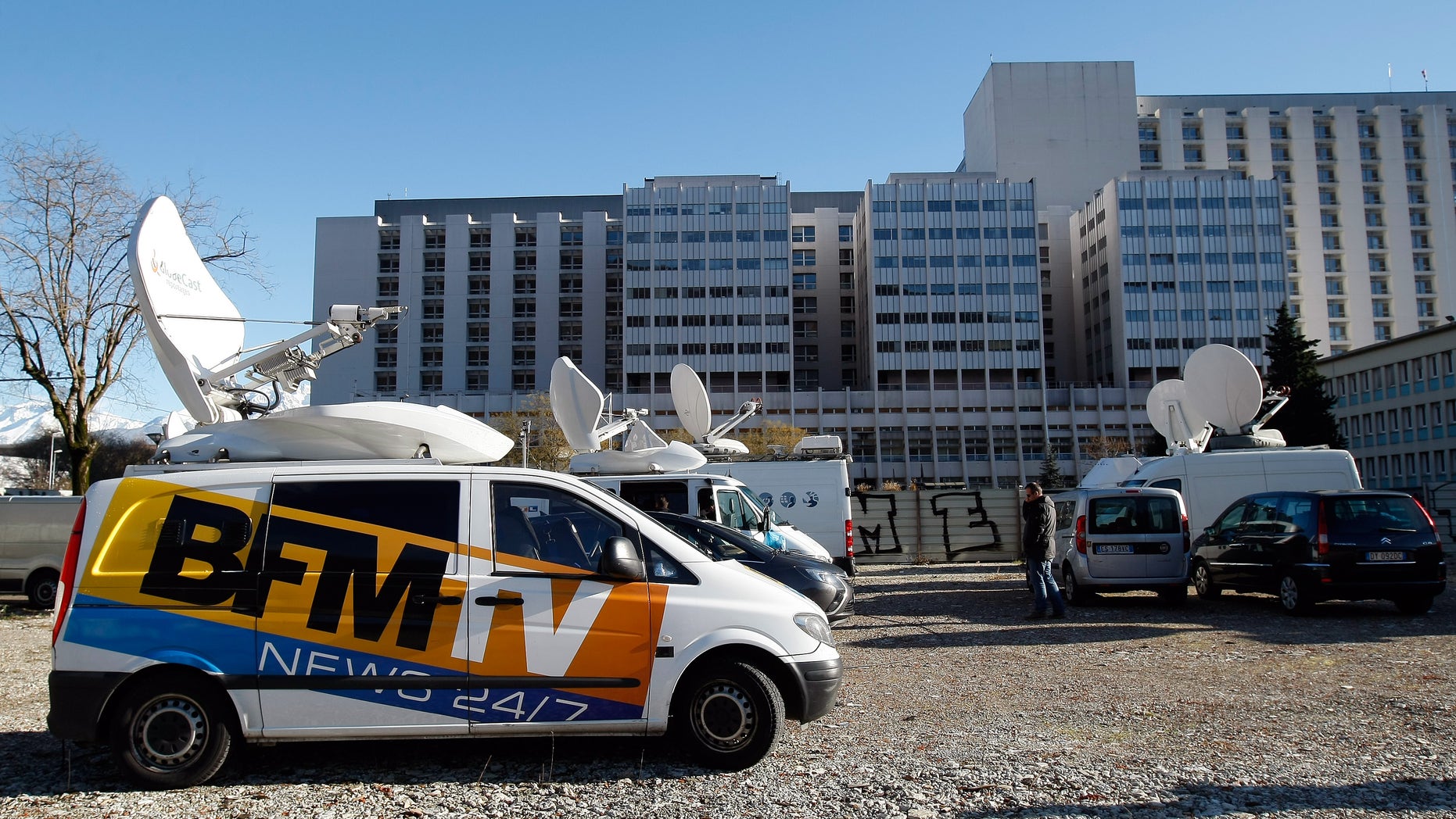 A TV van is parked in front of the Grenoble hospital, French Alps, Sunday, Jan. 5 , 2014, where former seven-time Formula One champion Michael Schumacher is being treated after sustaining a head injury during a ski accident. Schumacher has been in a medically induced coma since Sunday, Dec. 29, 2013, when he struck his head on a rock while on a family vacation. (AP Photo/Claude Paris)