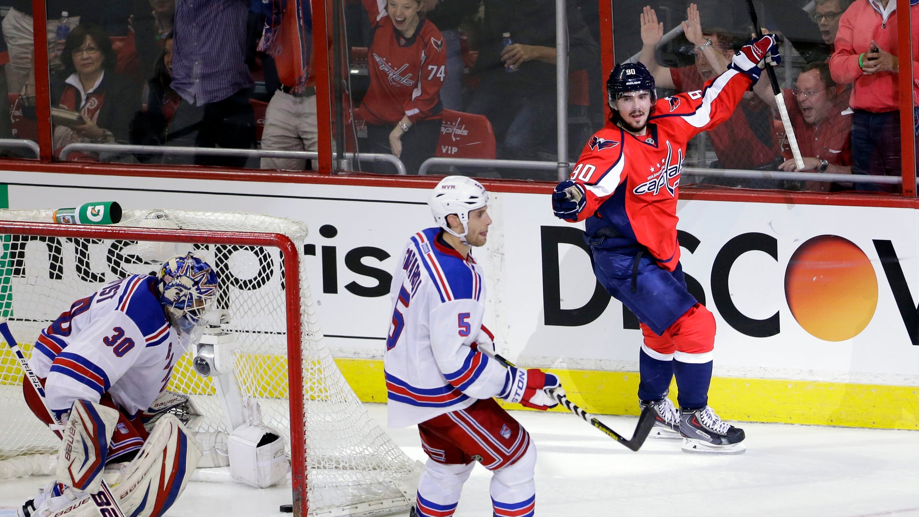 Washington Capitals center Marcus Johansson (90), from Sweden, celebrates his goal with New York Rangers goalie Henrik Lundqvist (30), also from Sweden, and defenseman Dan Girardi (5) standing nearby in the second period of Game 1 of a Stanley Cup NHL playoff hockey series on Thursday, May 2, 2013, in Washington. (AP Photo/Alex Brandon)